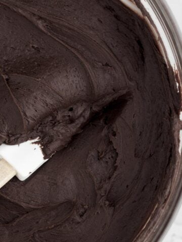 Sweet, luscious and silky smooth Chocolate Cream Cheese Frosting in a bowl with a spatula.