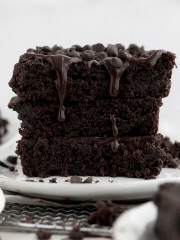 Chocolate ganache drips seductively down a stack of three slices of Chocolate Loaf Cake.