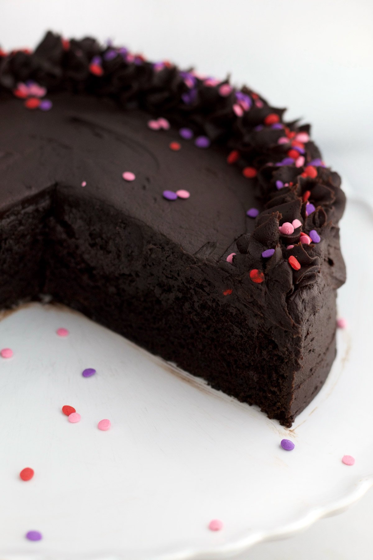 Missing slices reveal a soft temptation of the chocolate cake's warm and inviting interior.