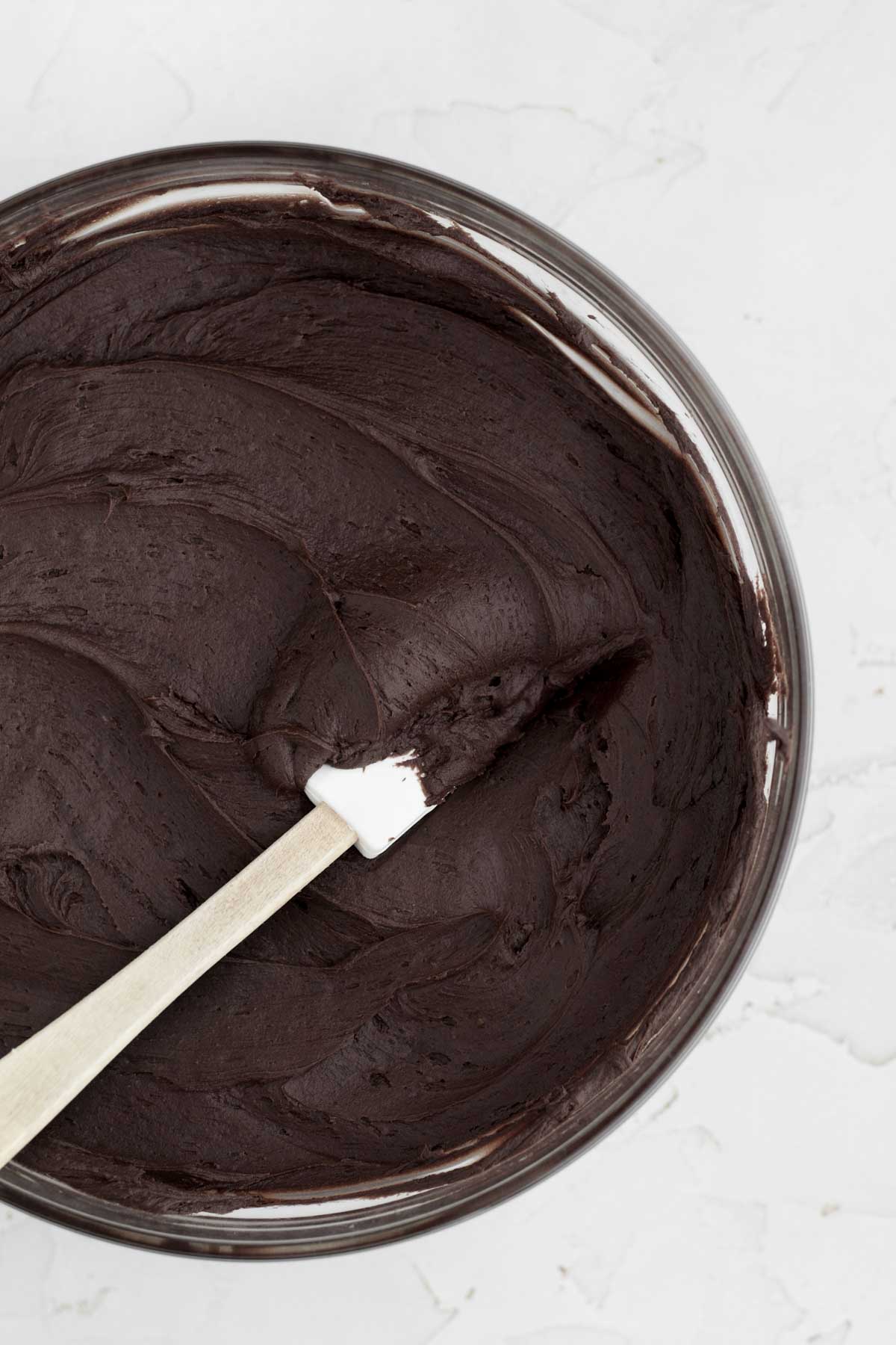 Silky smooth chocolate cream cheese frosting in a bowl.