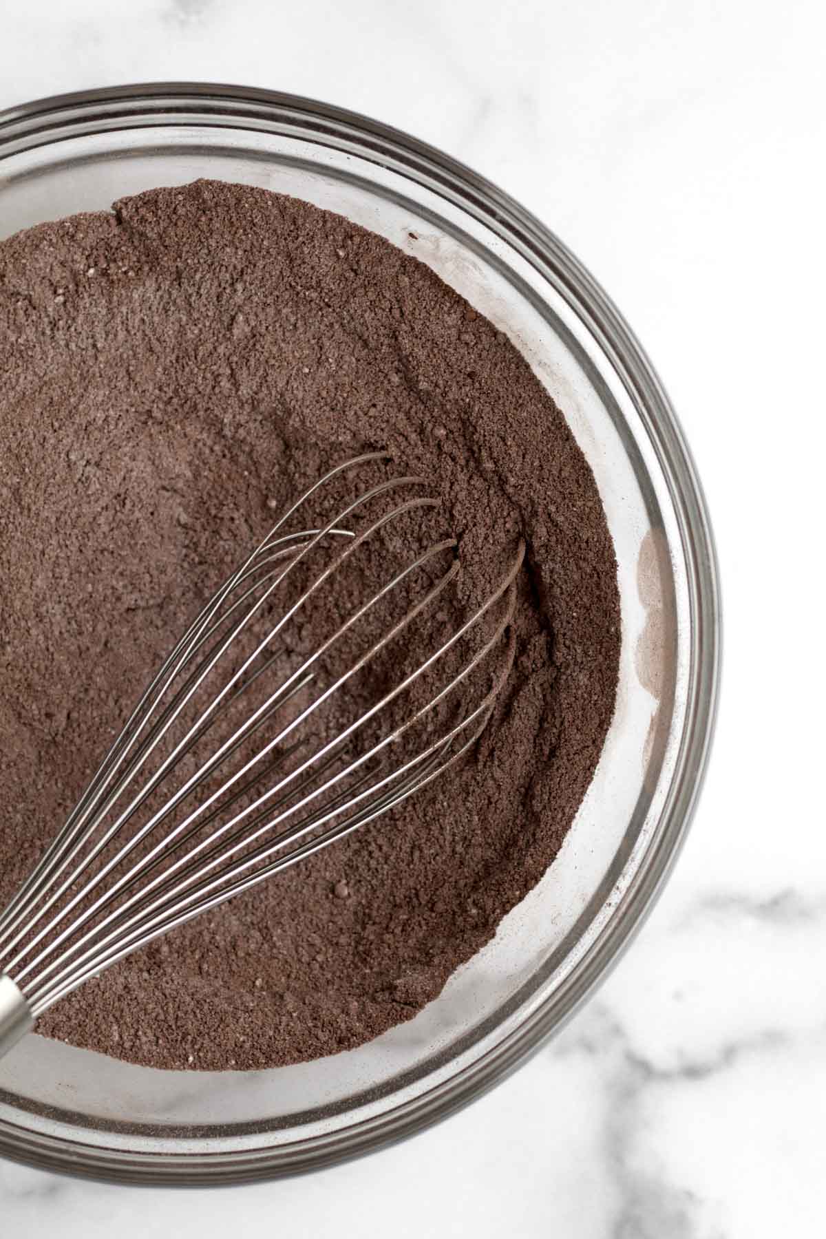 A whisk with the chocolate dry ingredients.