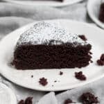 An inviting chocolatey slice of chocolate olive oil cake dusted with confectioners’ sugar.
