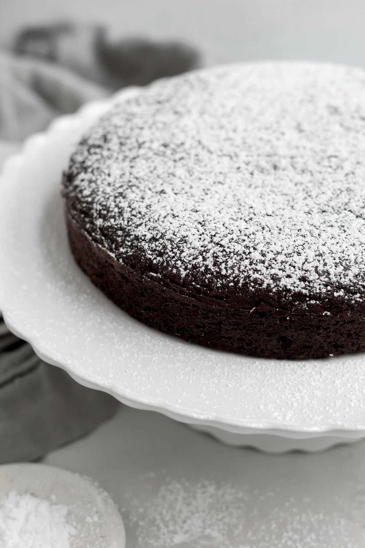 Sweet white and airy sugar sits atop this rich delicious Chocolate Olive Oil Cake.