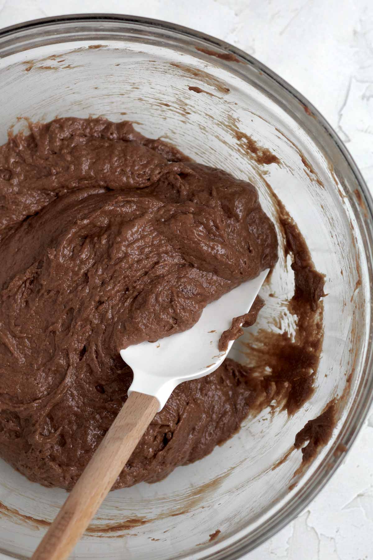 Mixing the wet and dry ingredients into a batter.