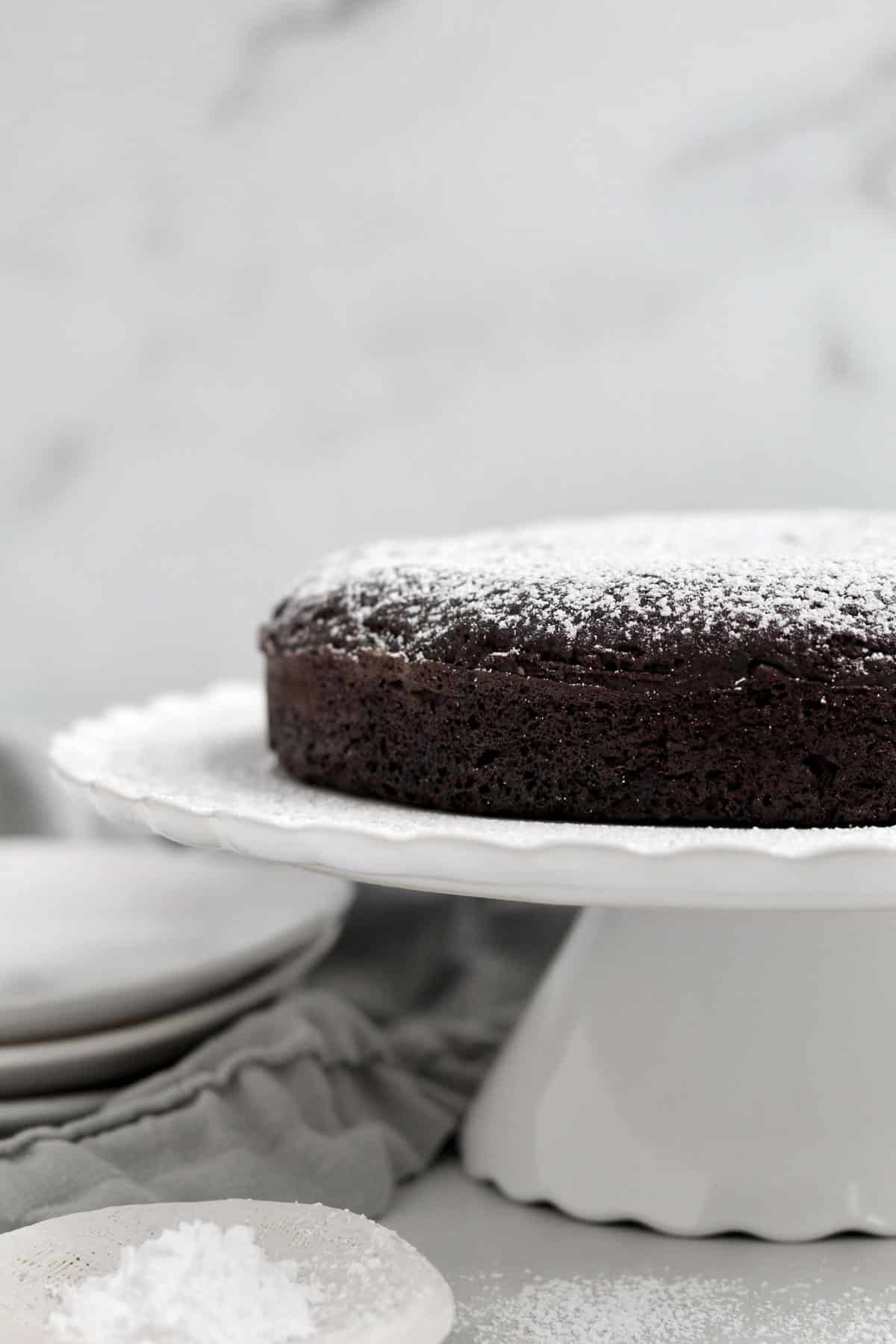 Dusting the top of the cake with confectioners' sugar.