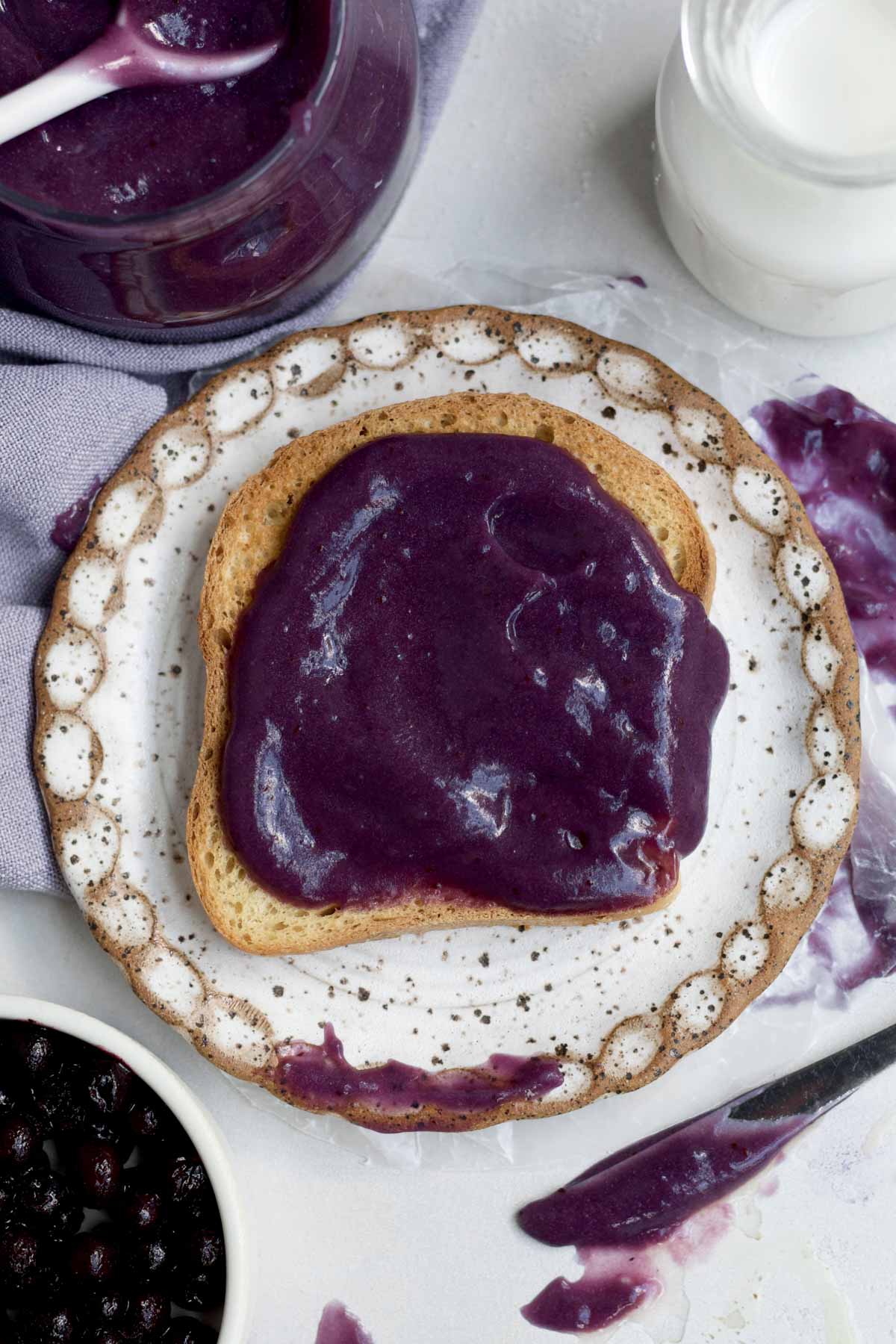 Velvety purple blueberry curd on a crisp piece of toast.