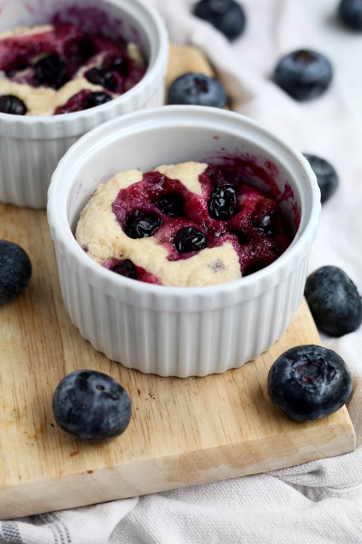 Warm and quick blueberry mug cakes ready to be enjoyed.