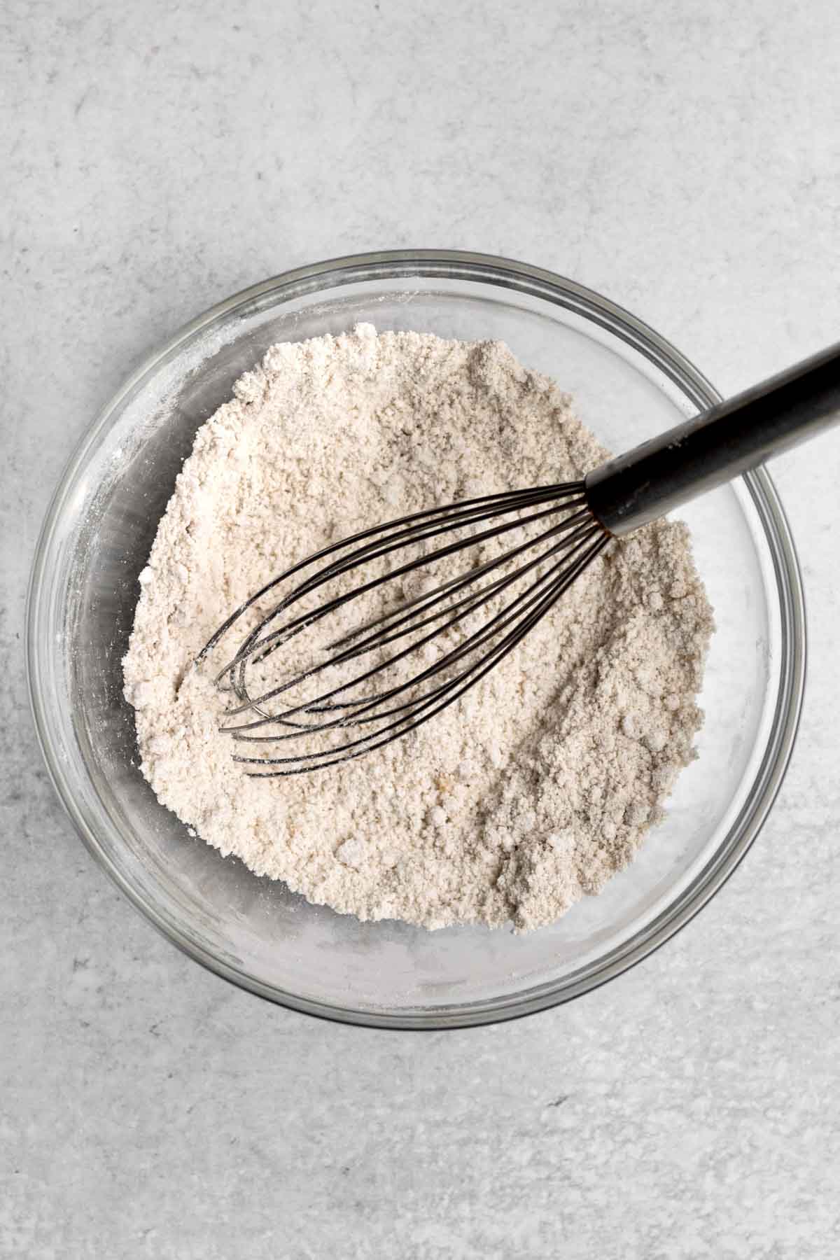 A whisk with the white dry ingredients.