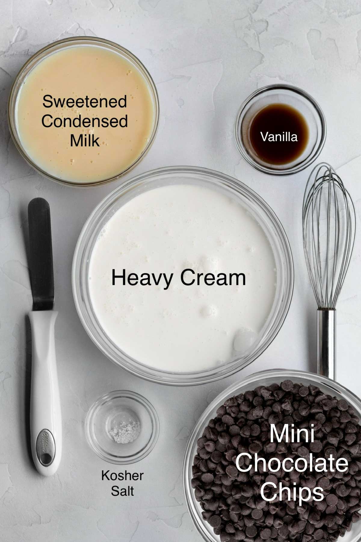 Bowls of Sweetened condensed milk, vanilla, heavy cream, kosher salt, and mini chocolate chips.