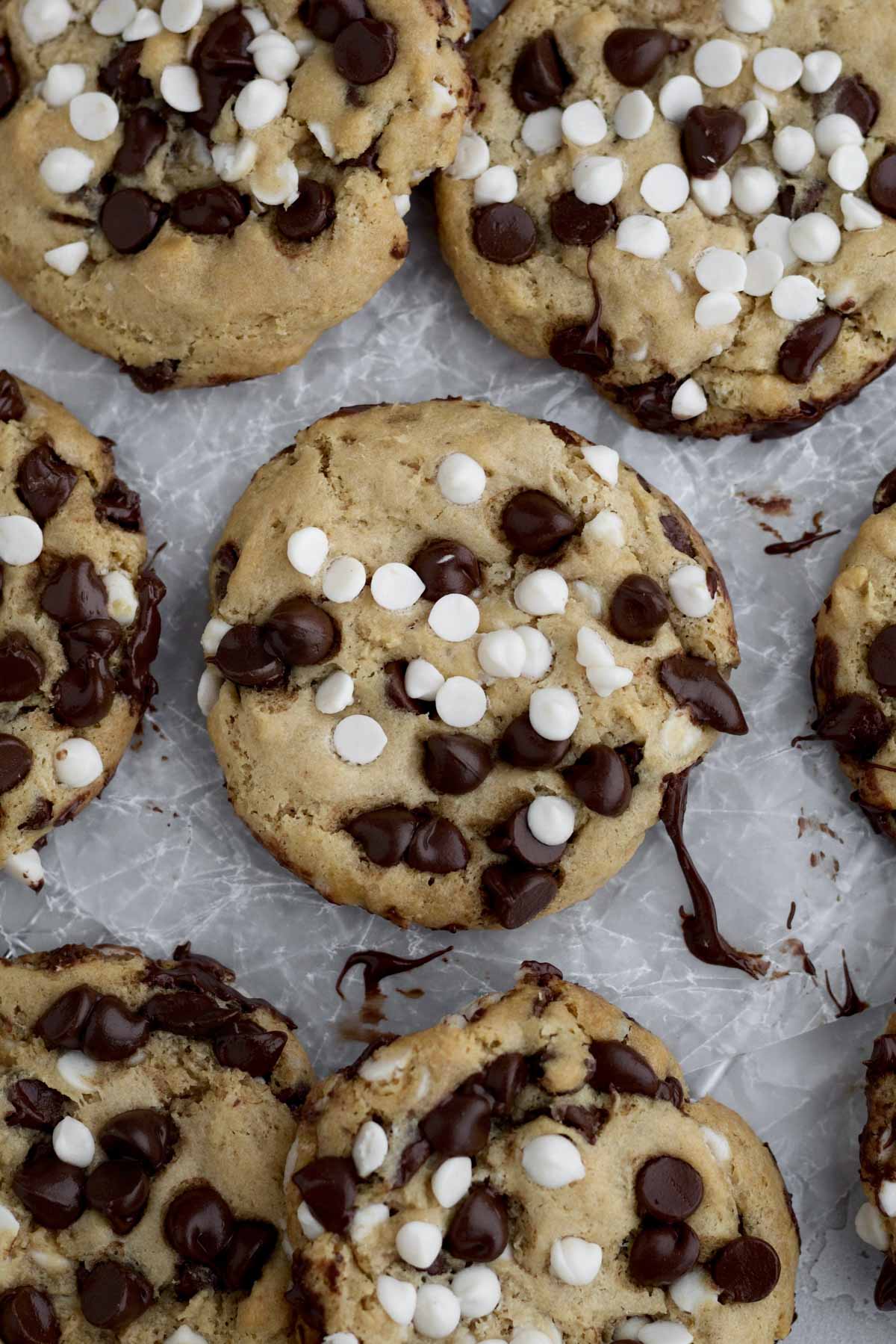 Creamy white chocolate chips and sweet chocolate chips melt slightly atop this crispy cookie.