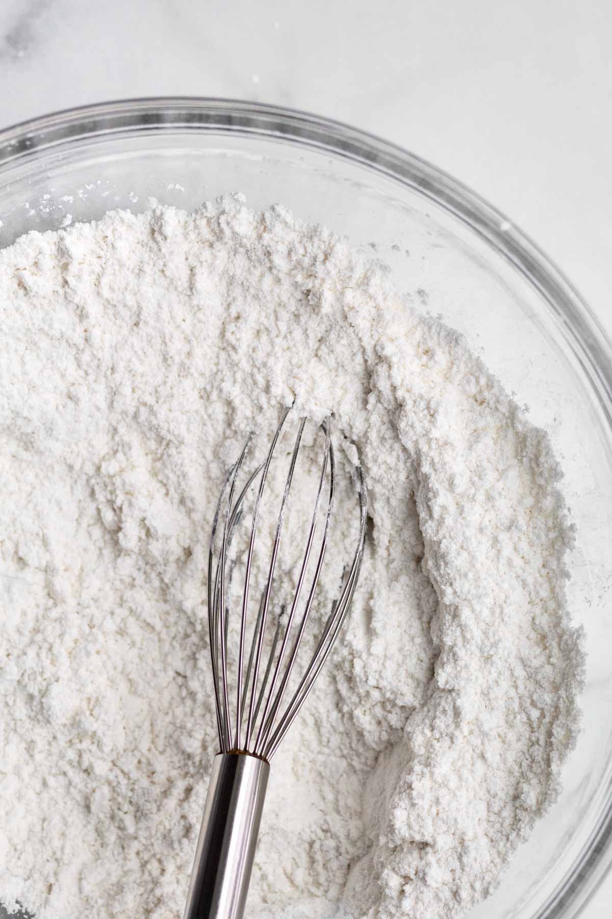 A whisk with the white dry ingredients.