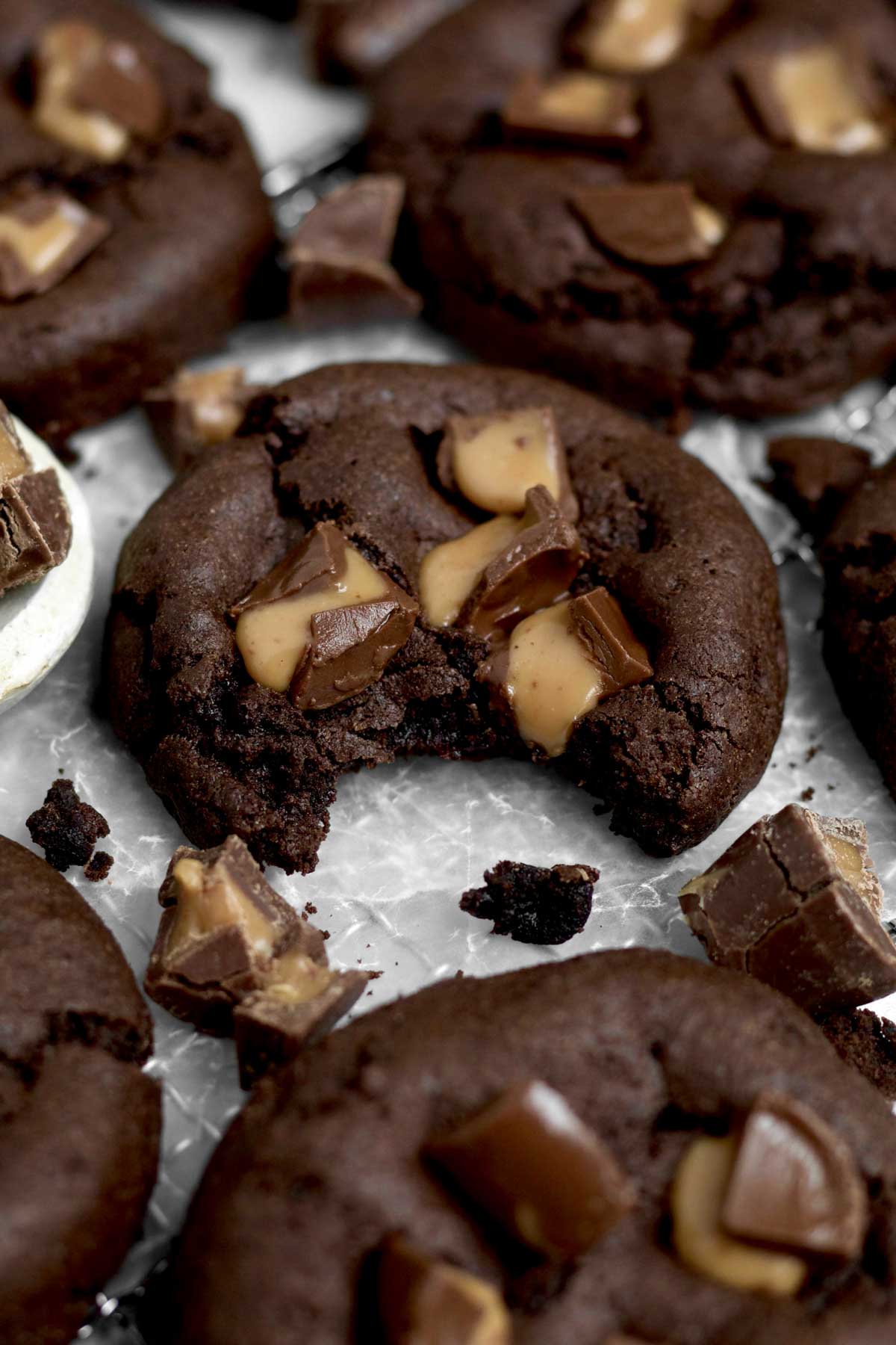 A bite removed from the Rolo Cookie displays the tasty tender texture of the cookie.