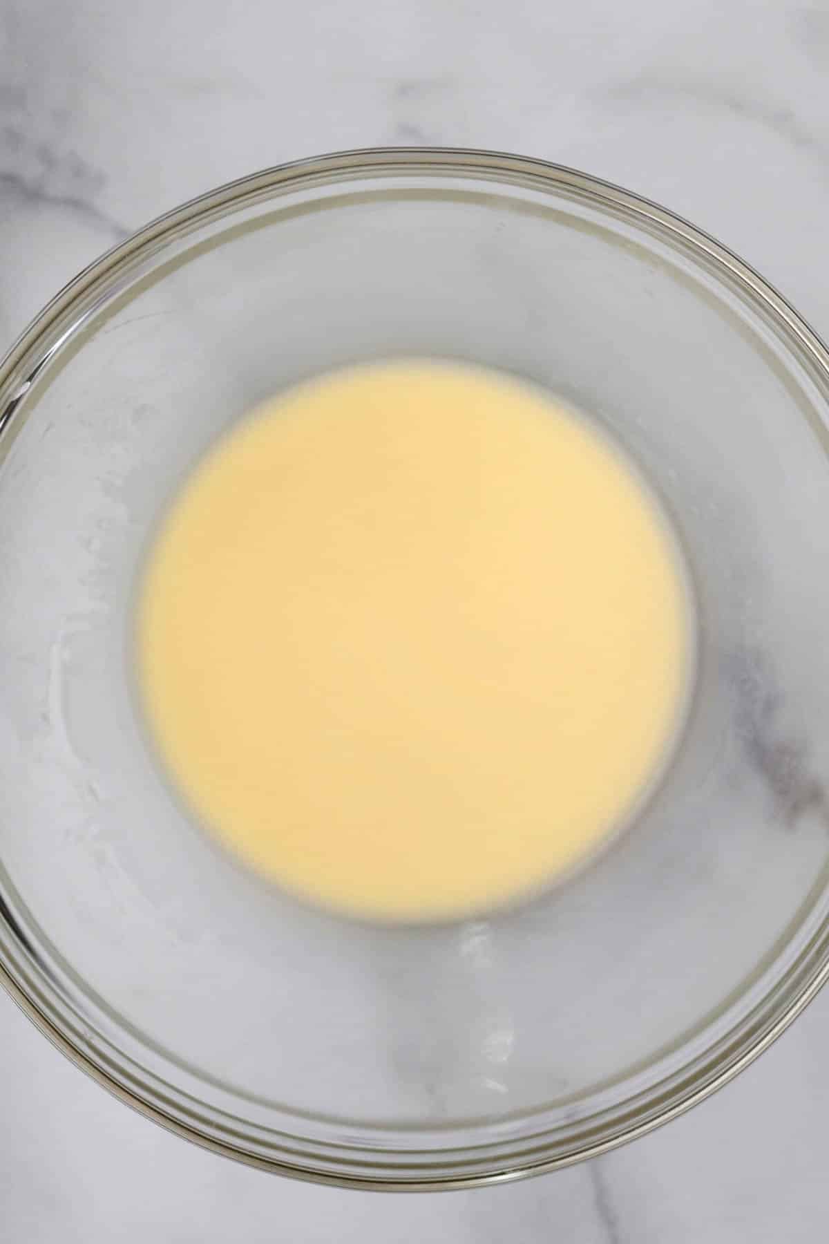 Yellow melted butter in a bowl.