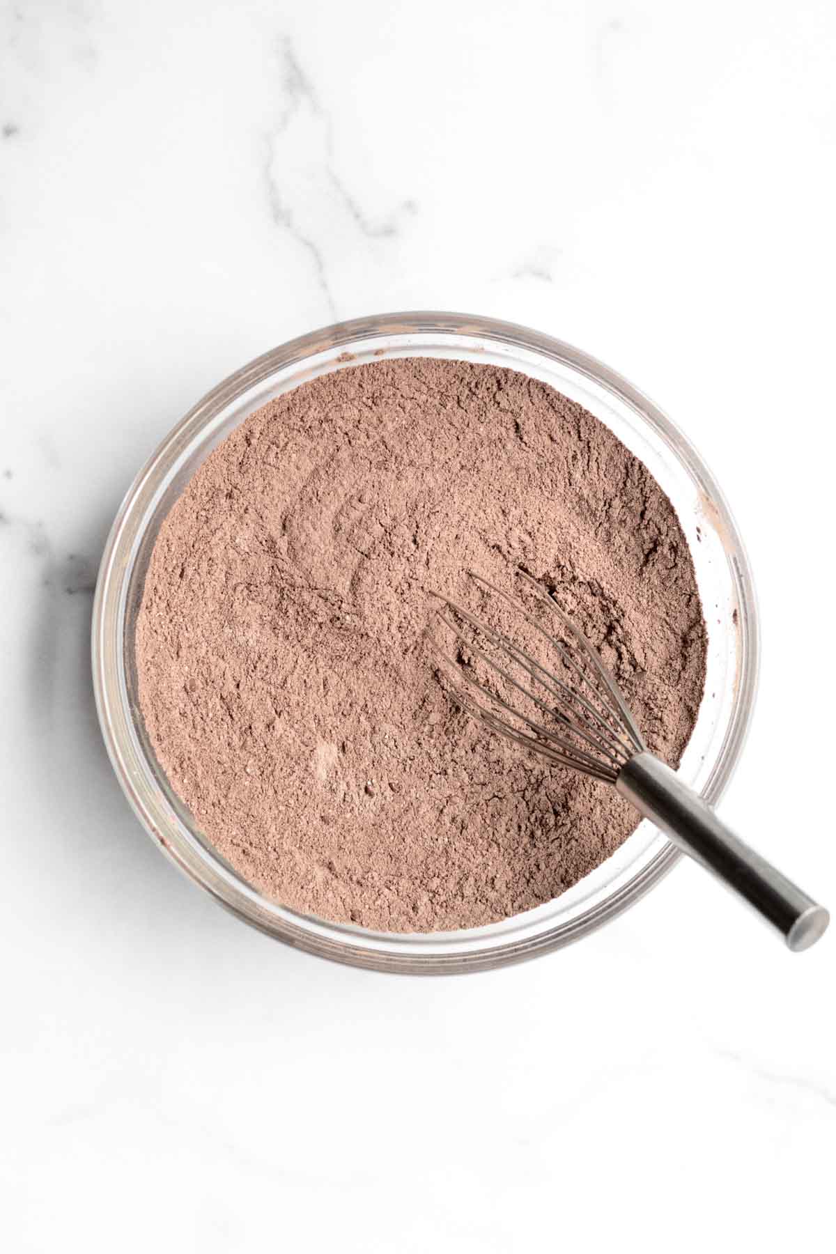 A whisk with the chocolate dry ingredients.