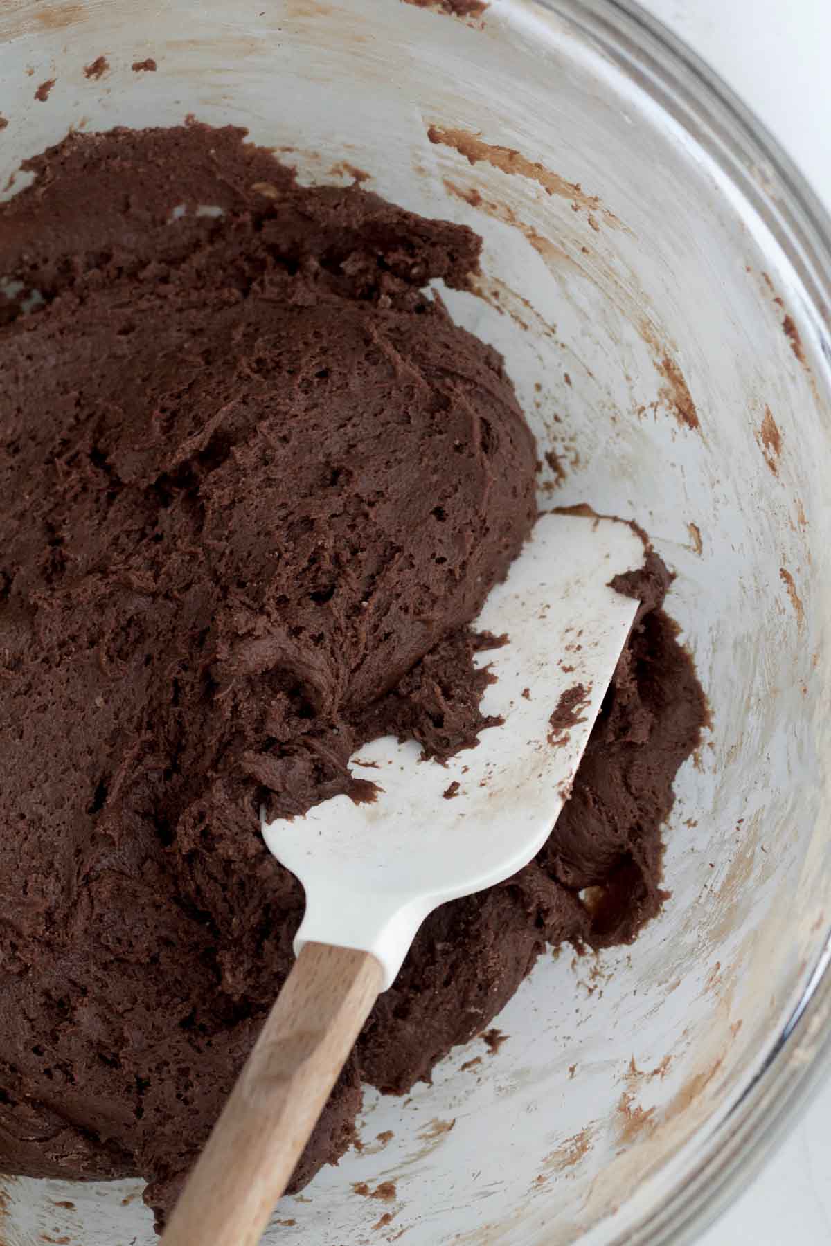 Mixing the wet and dry ingredients into a chocolate cookie dough.