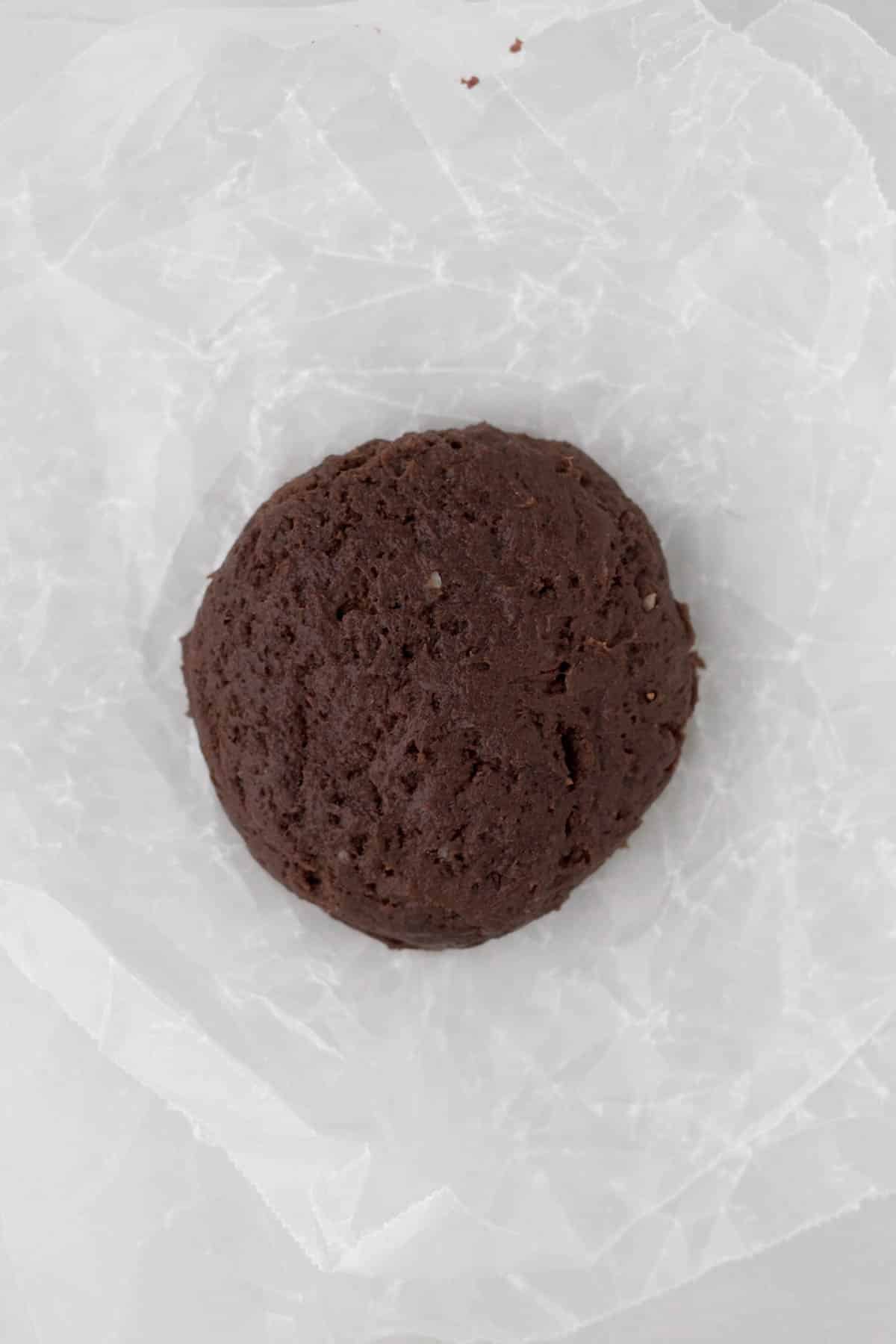 A flattened frozen chocolate cookie dough ball.