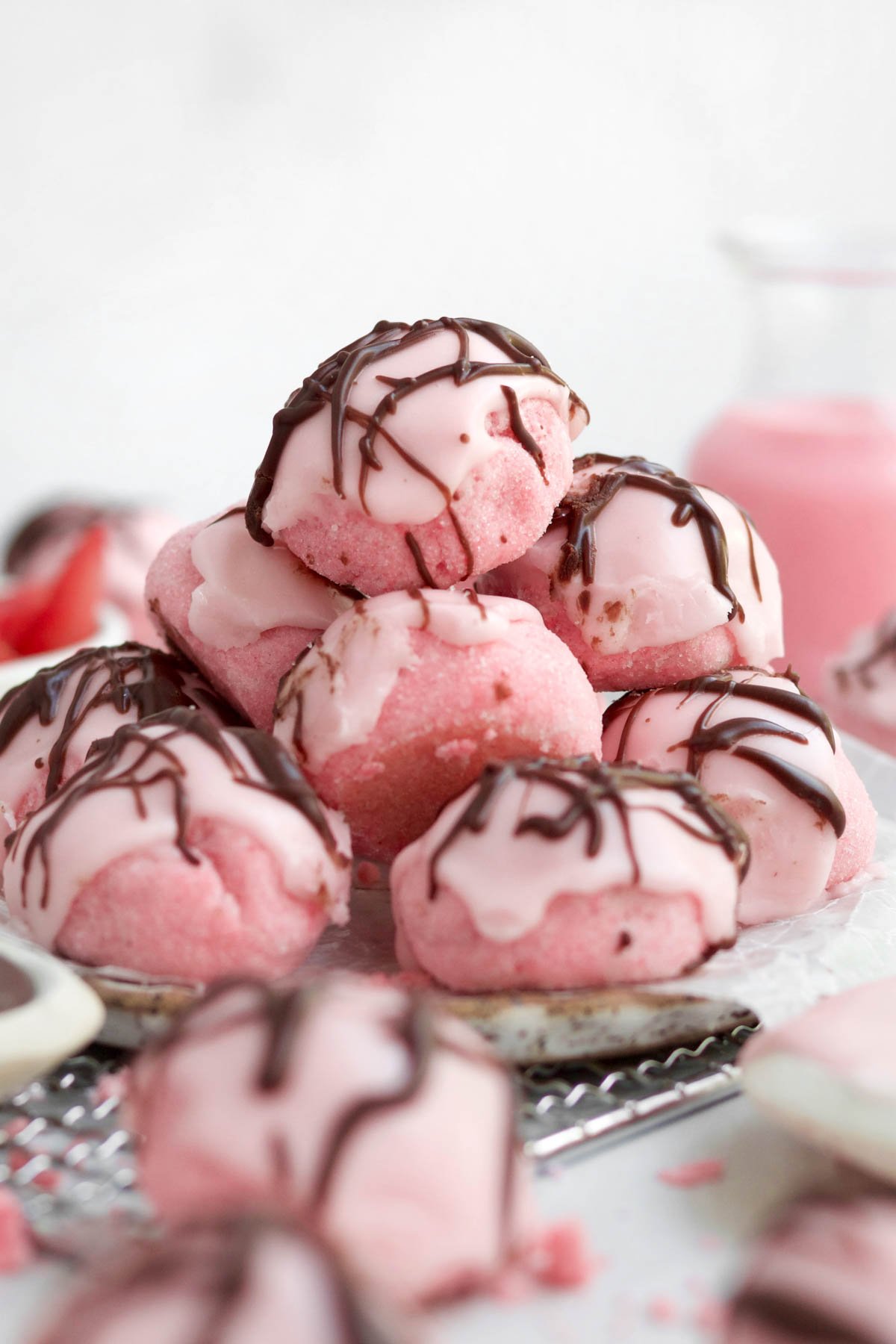 Strawberry Shortbread Cookies drizzled in chocolate and glazed with strawberry topping in a scrumptious pile.