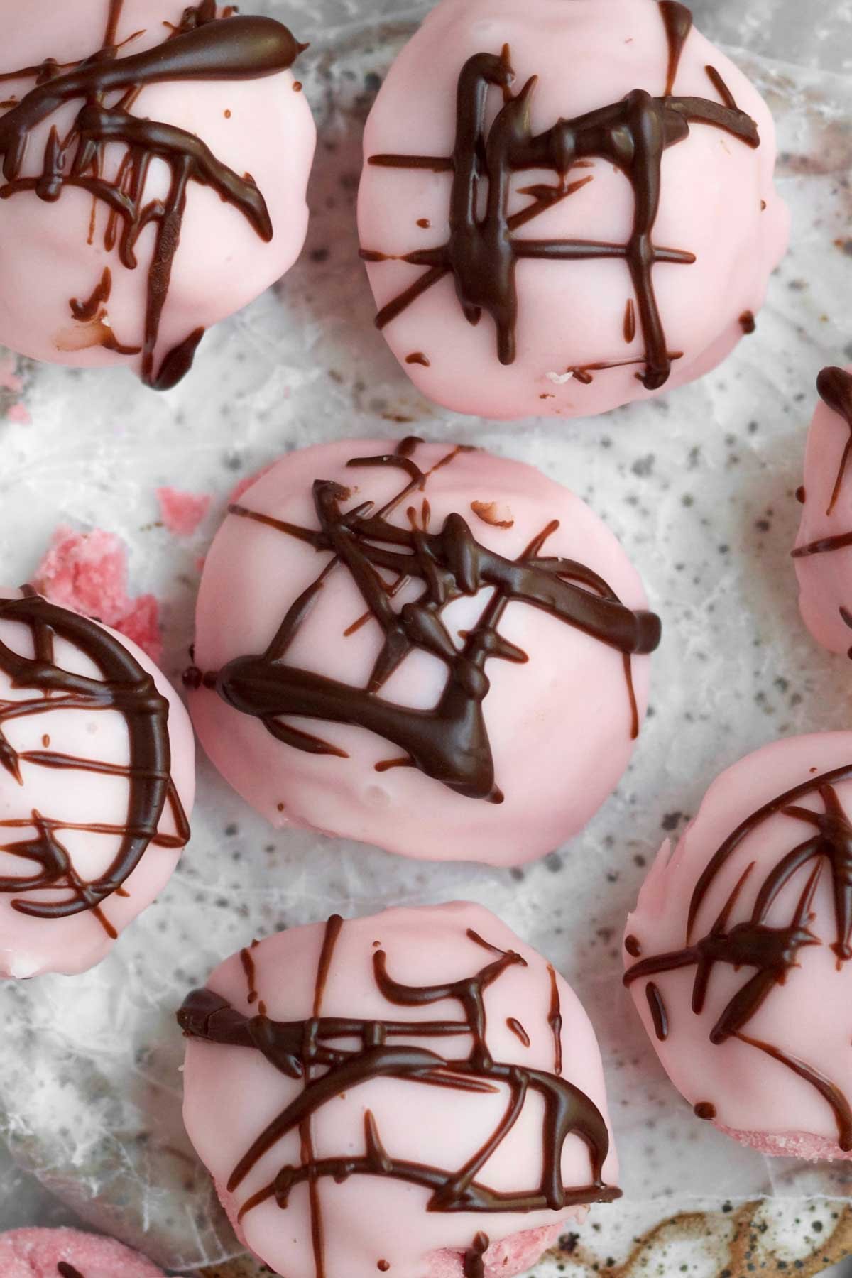 Chocolate drizzled recklessly atop these bite-sized strawberry delights.