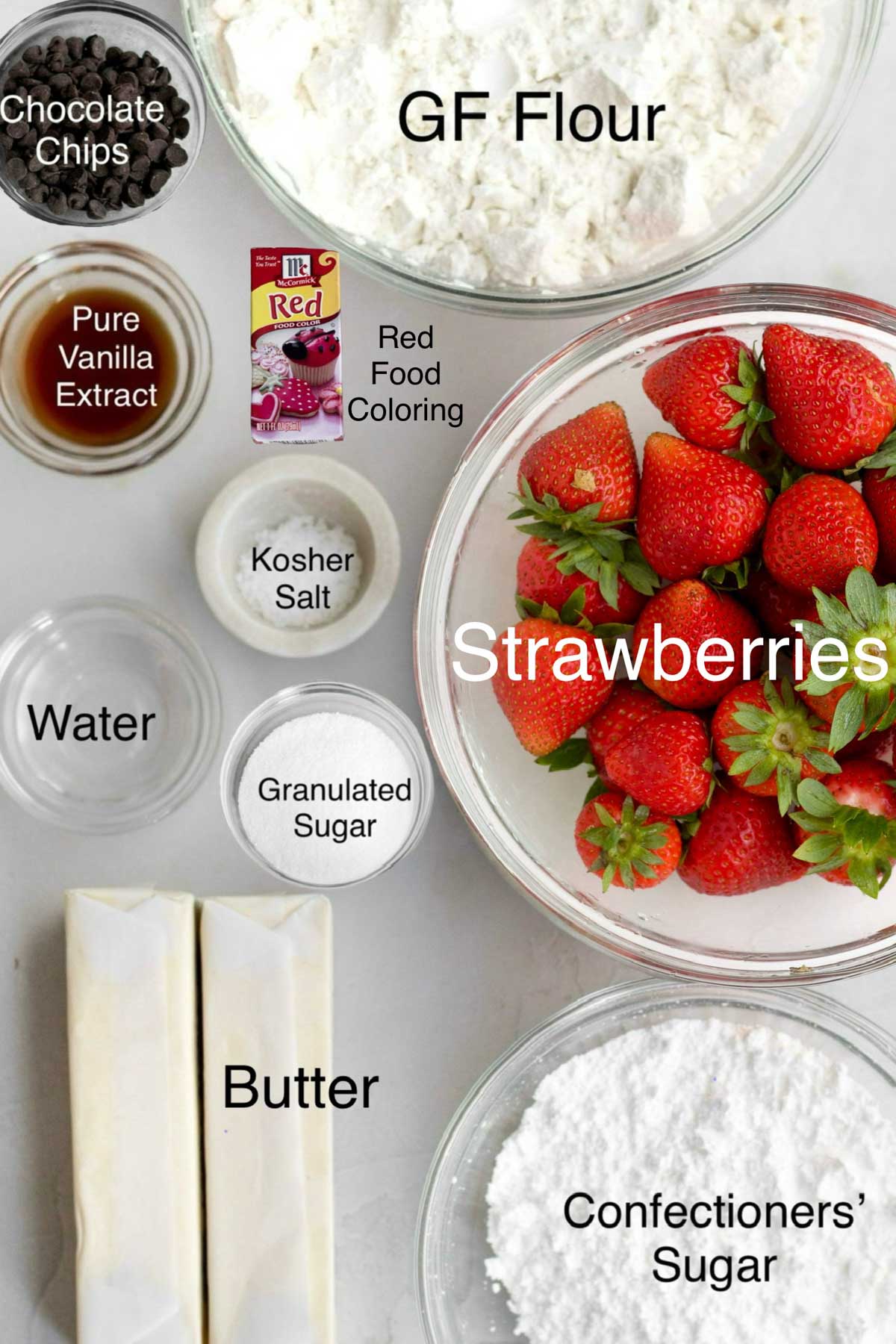Chocolate Chips, Gluten Free Flour, Pure Vanilla Extract, Red Food Coloring, Kosher salt, whole strawberries, water, granulated sugar, butter, and confectioners' sugar.