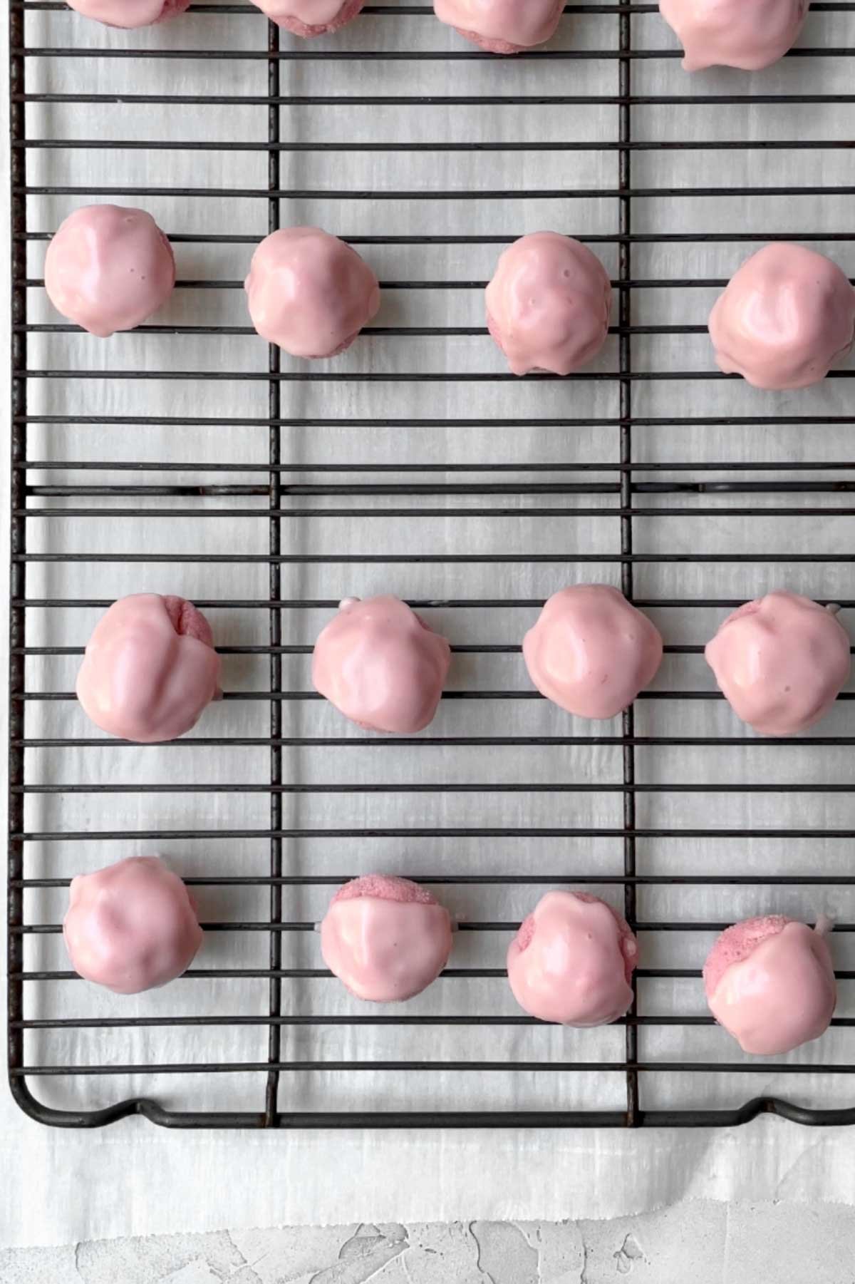 Strawberry Shortbread Cookies freshly dipped in strawberry glaze.