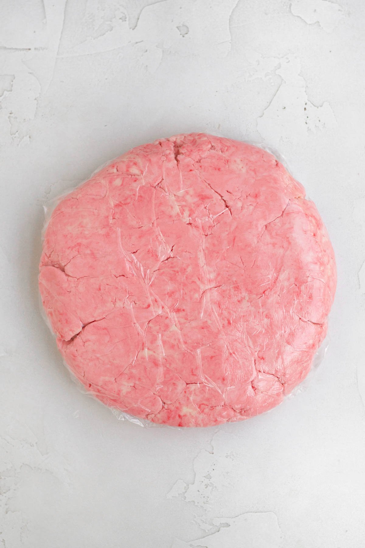 Strawberry Shortbread Cookie dough wrapped in plastic.