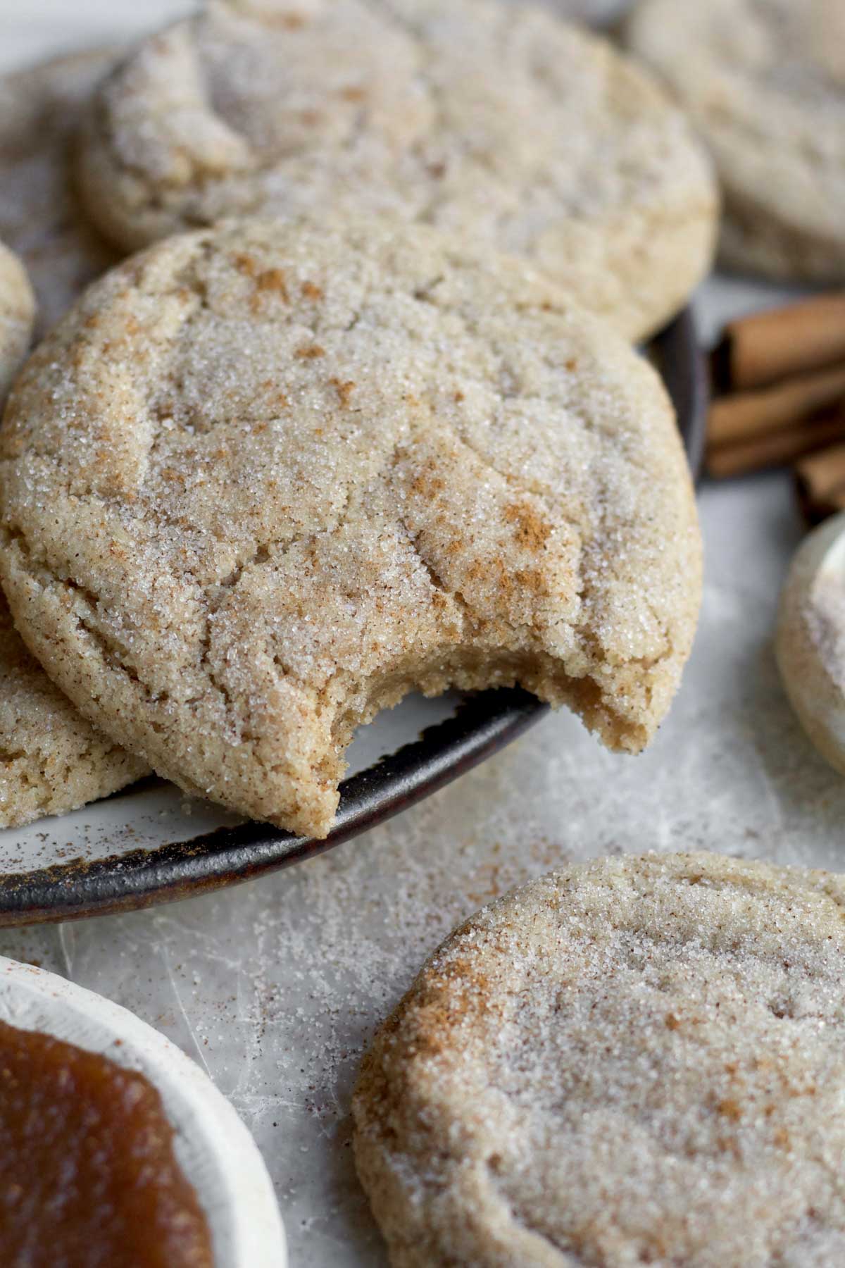 A plate of Apple Butter Cookies cascading with sweetness, one with bite.