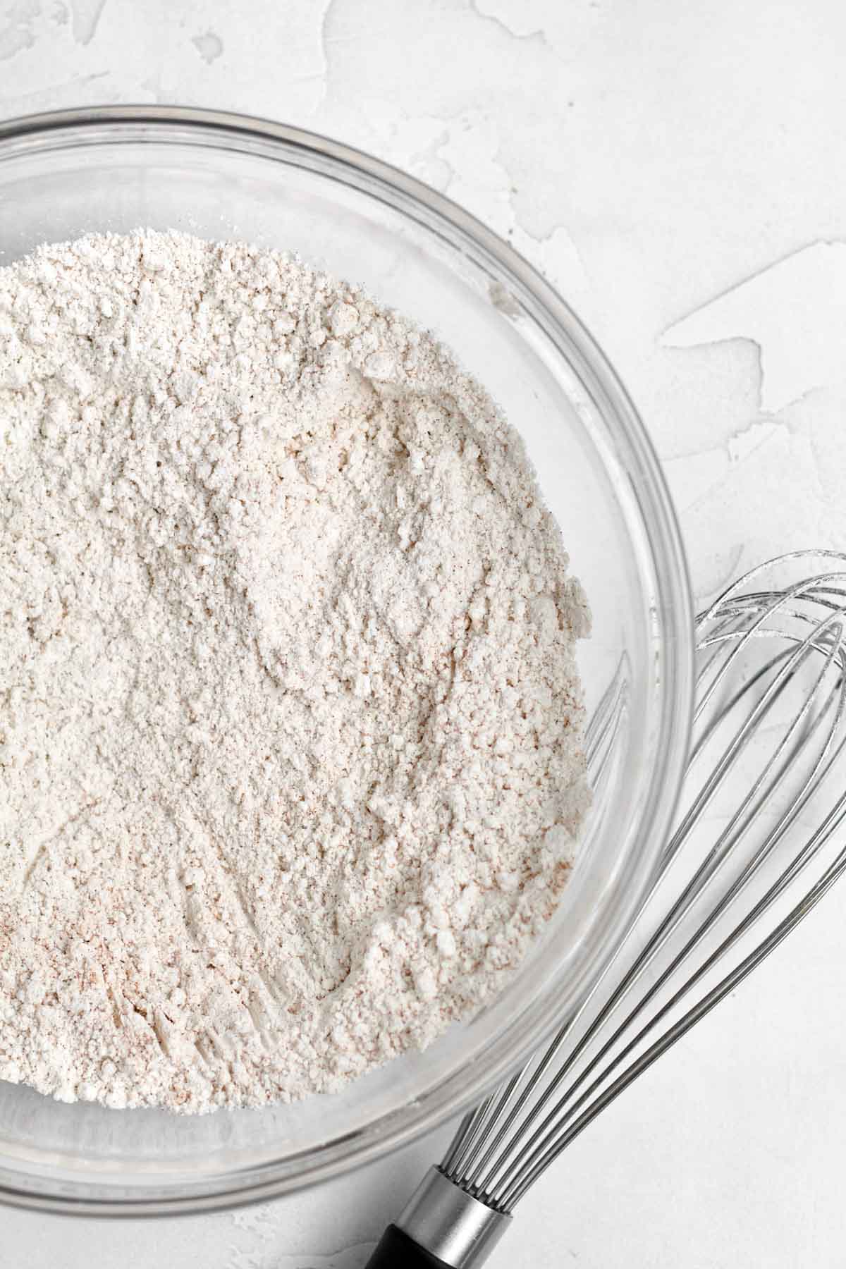 A whisk with dry ingredients.