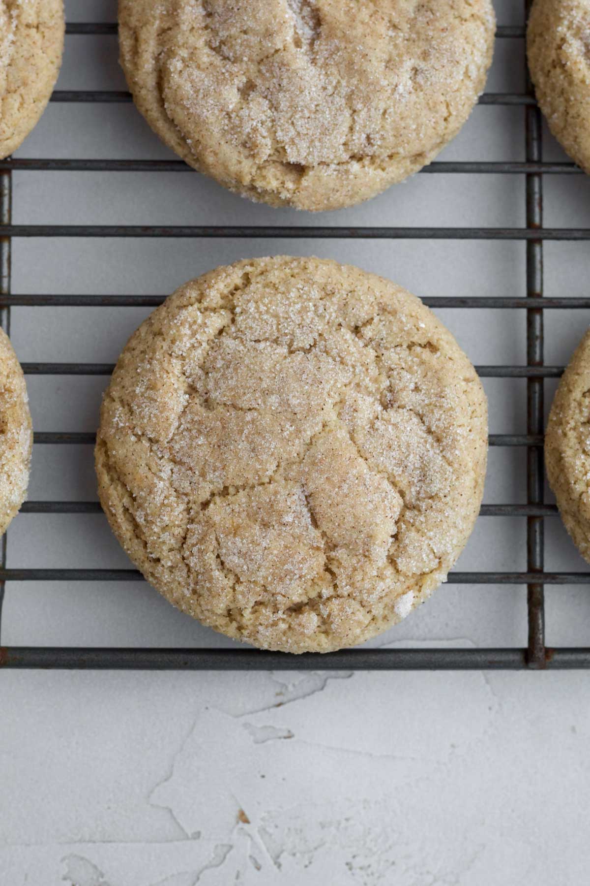 Crinkly warm and fresh baked Apple Butter Cookies resting on a baking rack.