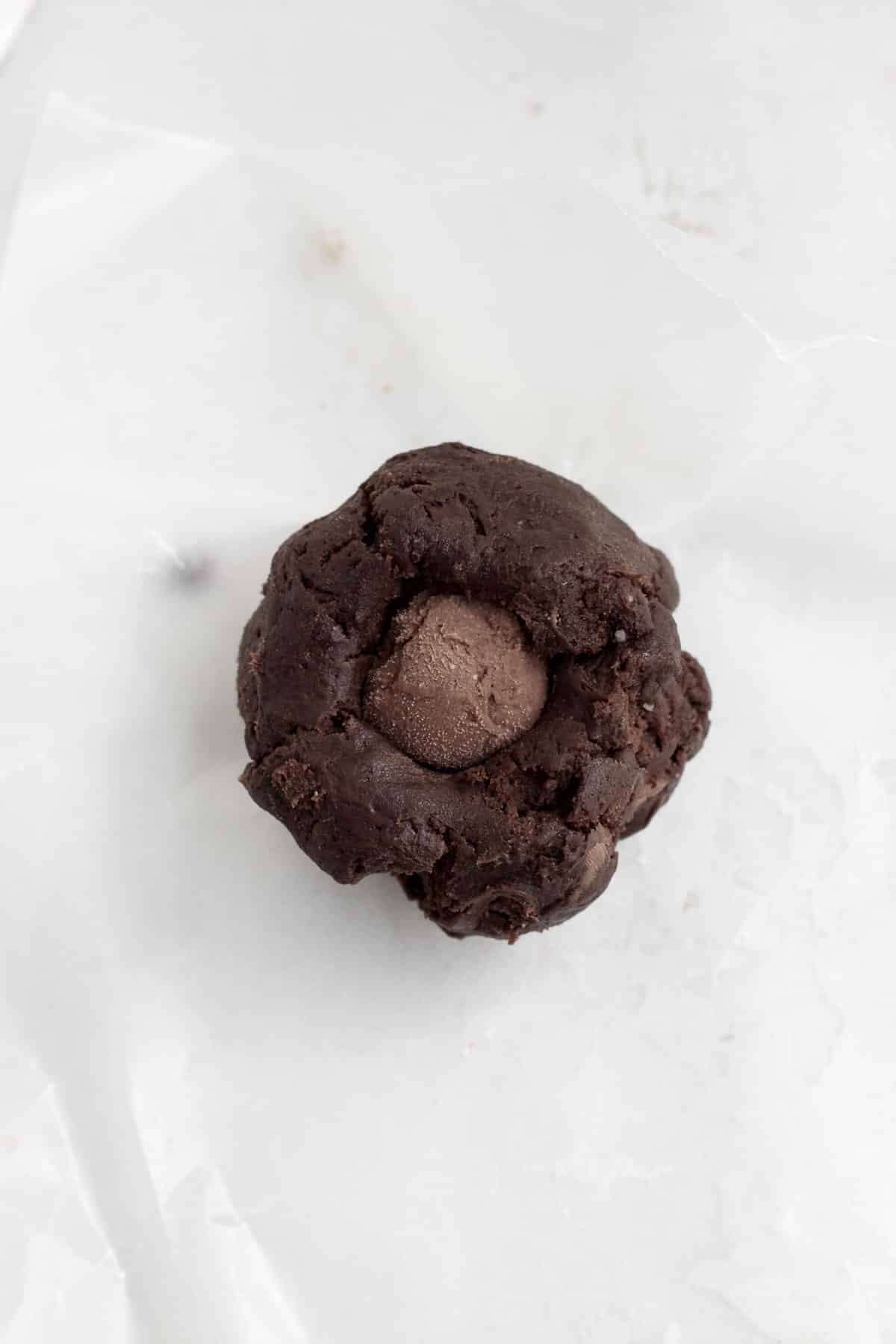 Balls of chocolate cookie dough stuffed with chocolate cheesecake filling.