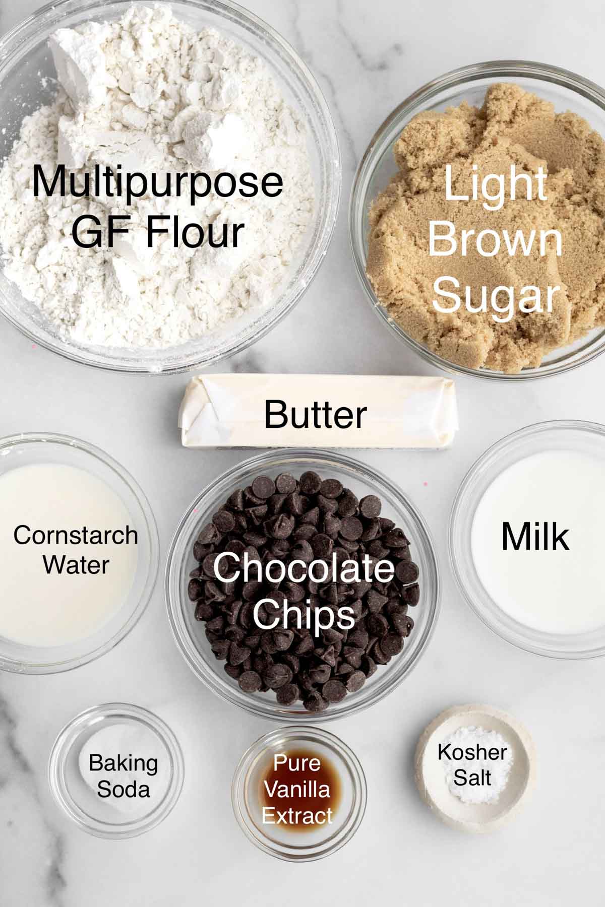 Multipurpose gluten free flour, light brown sugar, butter, cornstarch water, chocolate chips, milk, baking soda, pure vanilla extract, and kosher salt in separate containers.