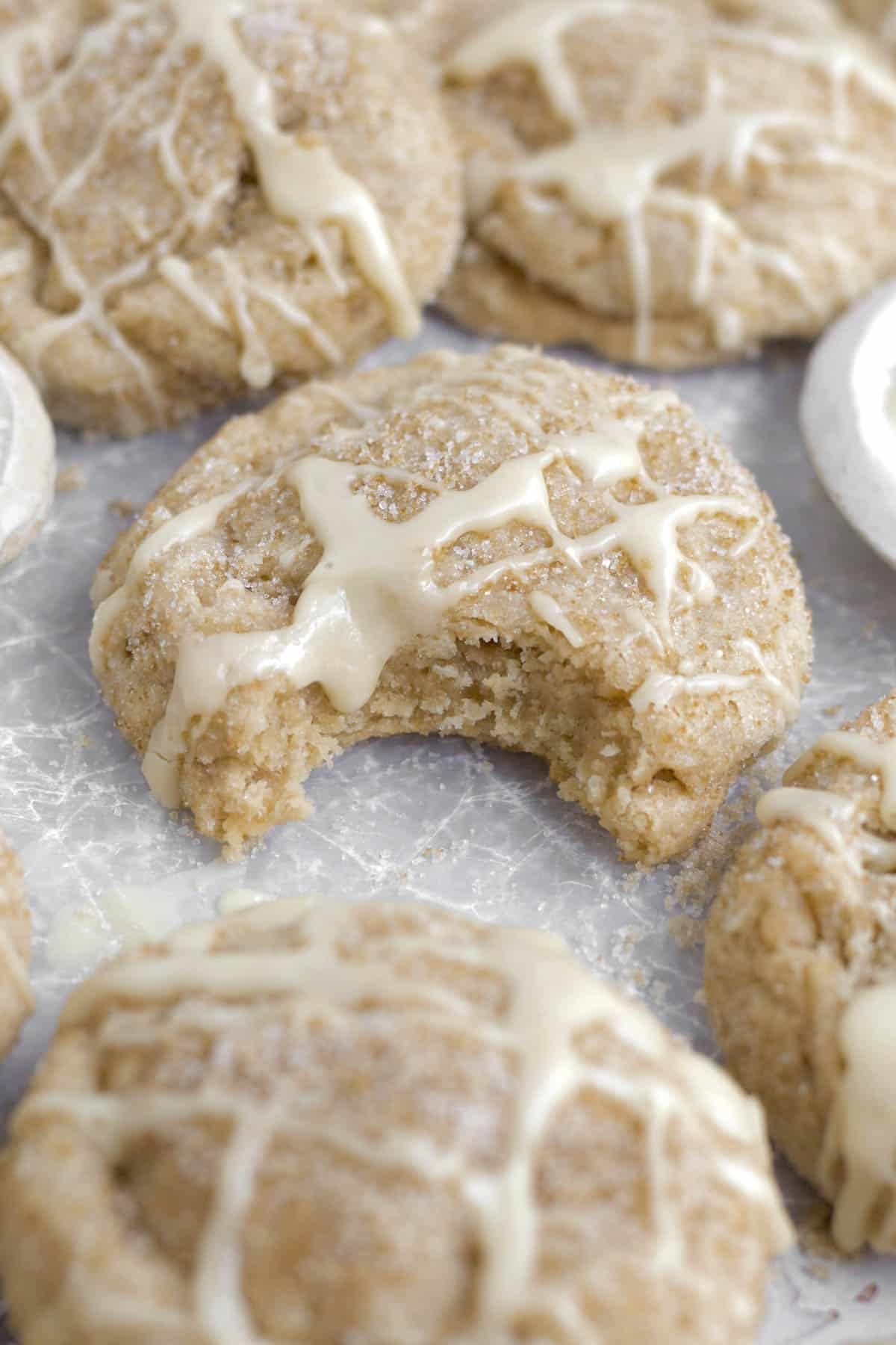 A bite reveals the soft interior of the delicious maple glazed Brown Sugar Maple Cookies.