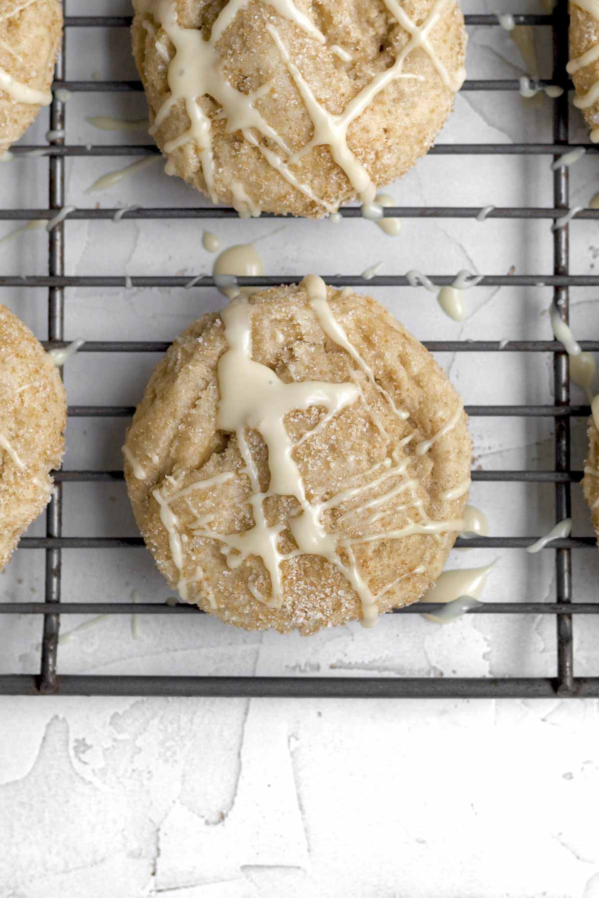 Drizzling the maple glaze in a crosshatch pattern on top of the cookie.