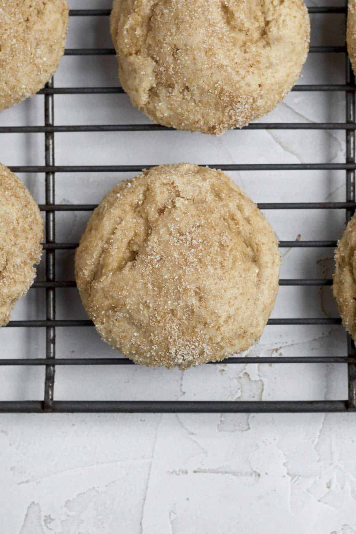 Baked brown sugar maple cookies resting on a rack.