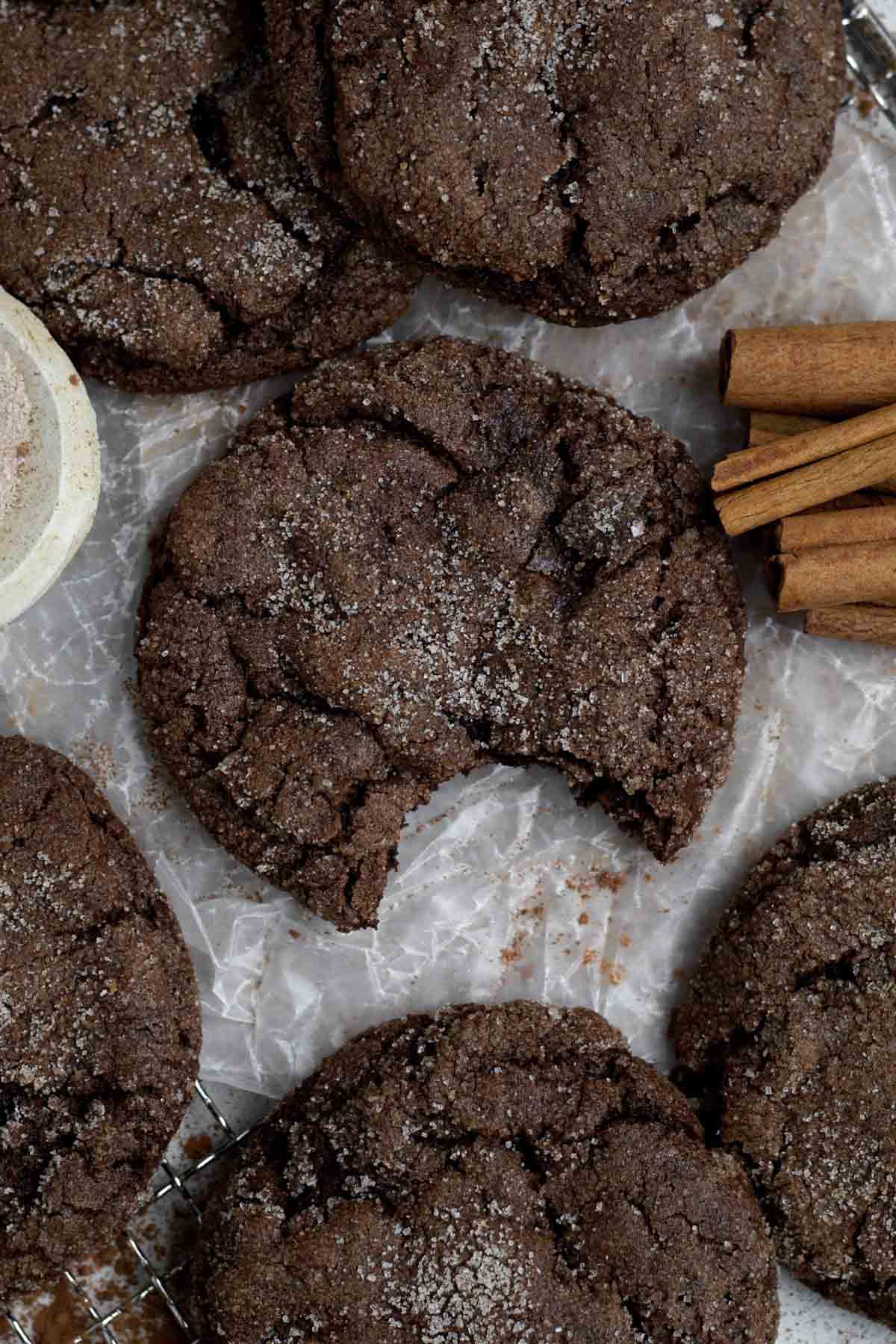 Soft and delicious Chocolate Cinnamon Cookie with a bite missing coated in cinnamon sugar.