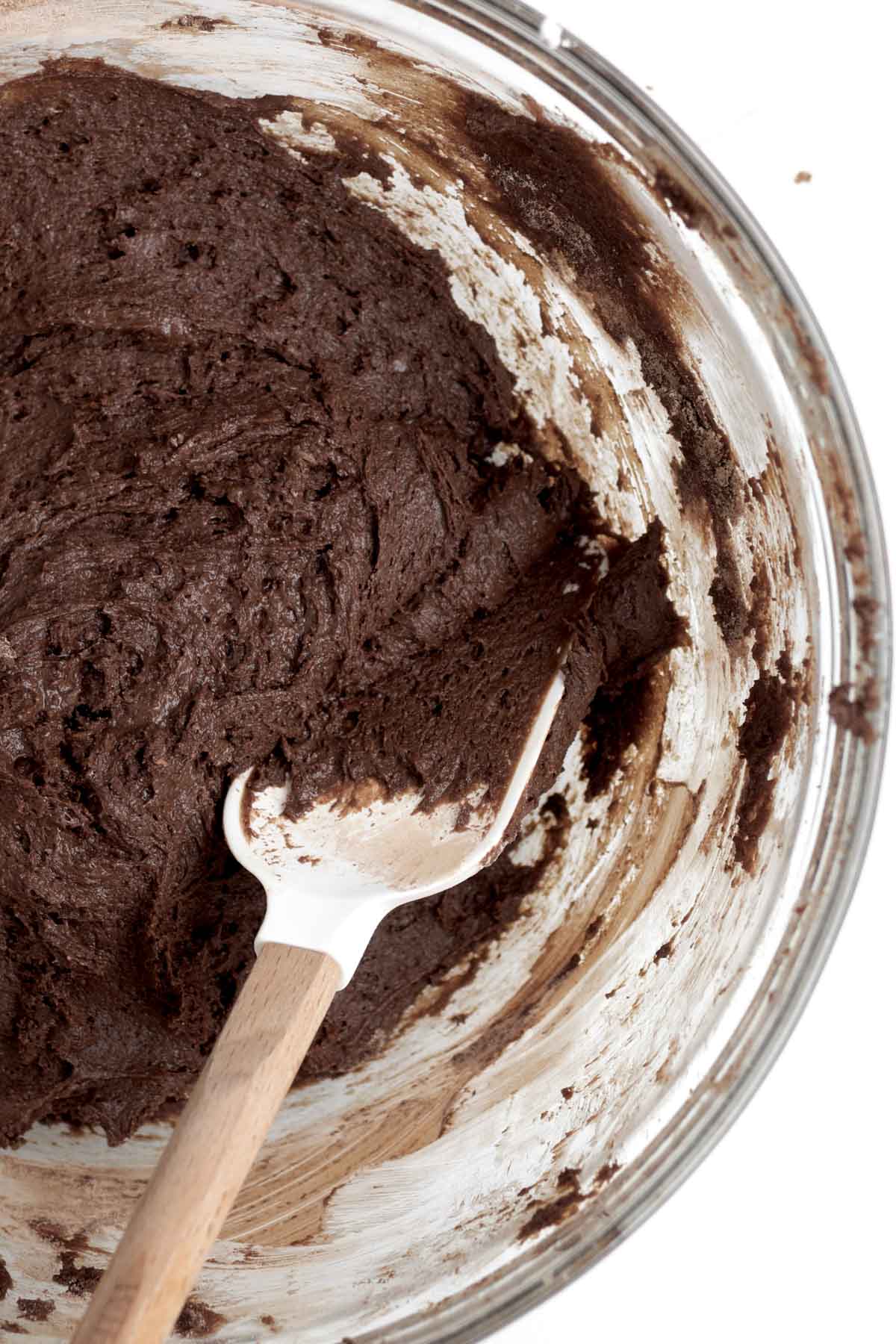 Mixing the wet and dry ingredients into a cookie dough batter.
