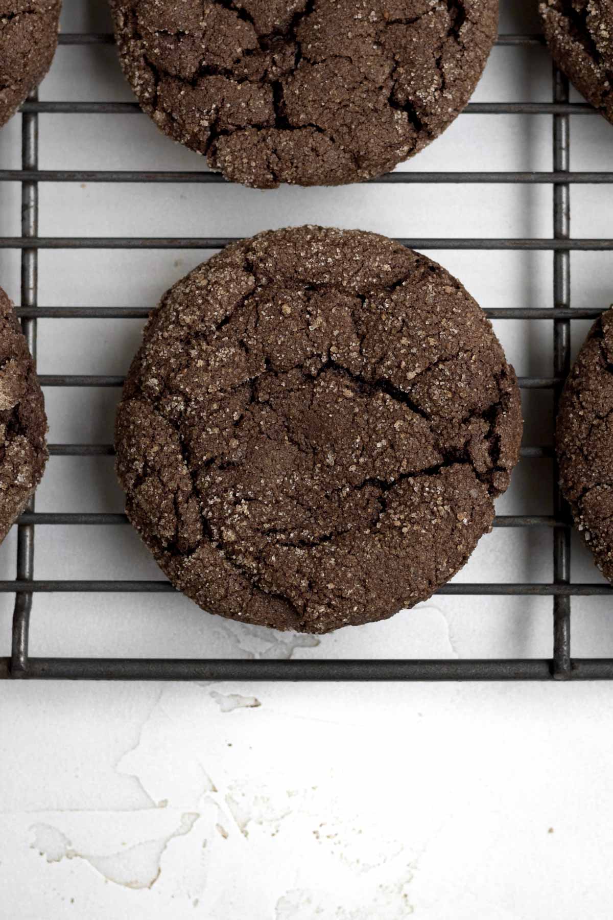A fresh baked Cinnamon Chocolate Cookie resting on a baking rack.
