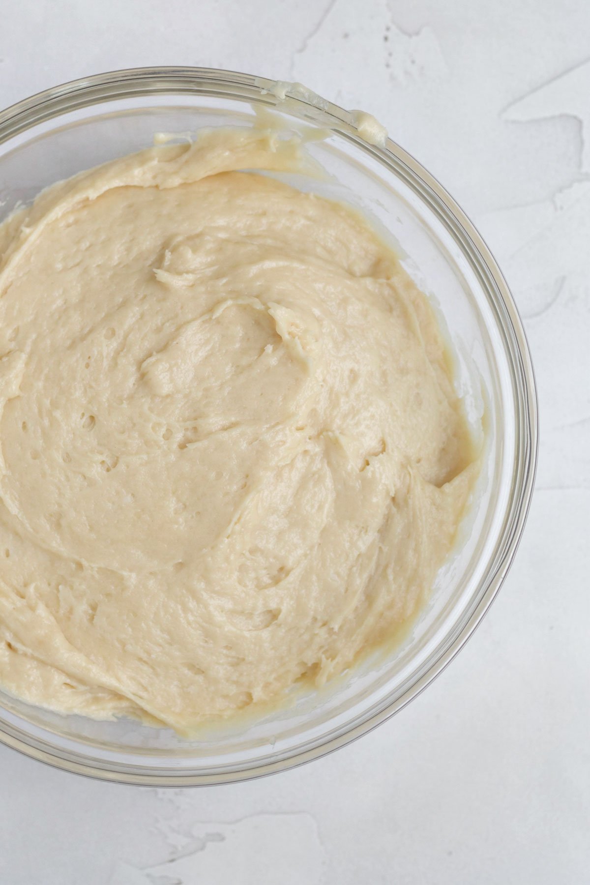 Mixing the wet and dry ingredients into a maple cake batter.