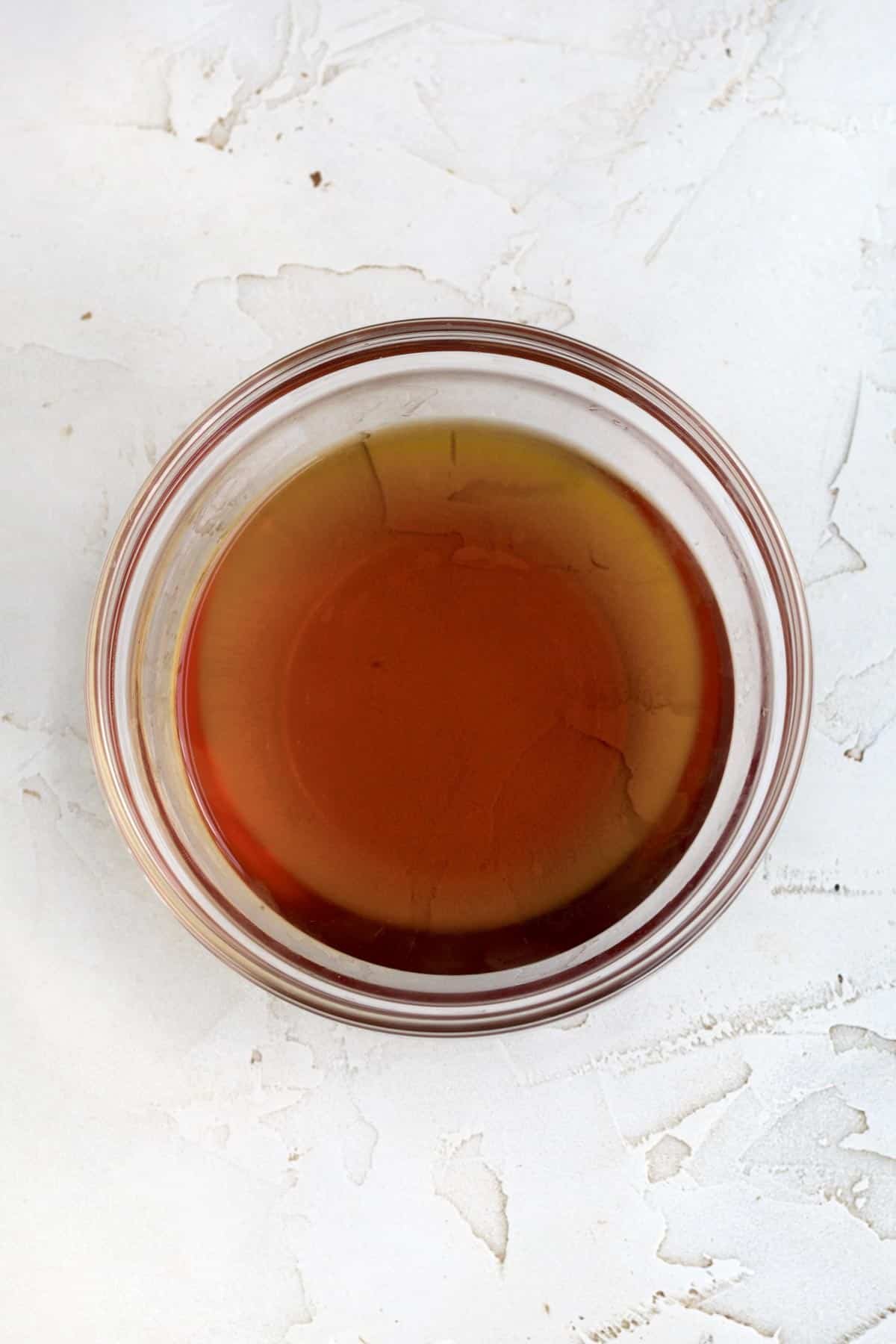 A bowl of warm apple cider reduction.