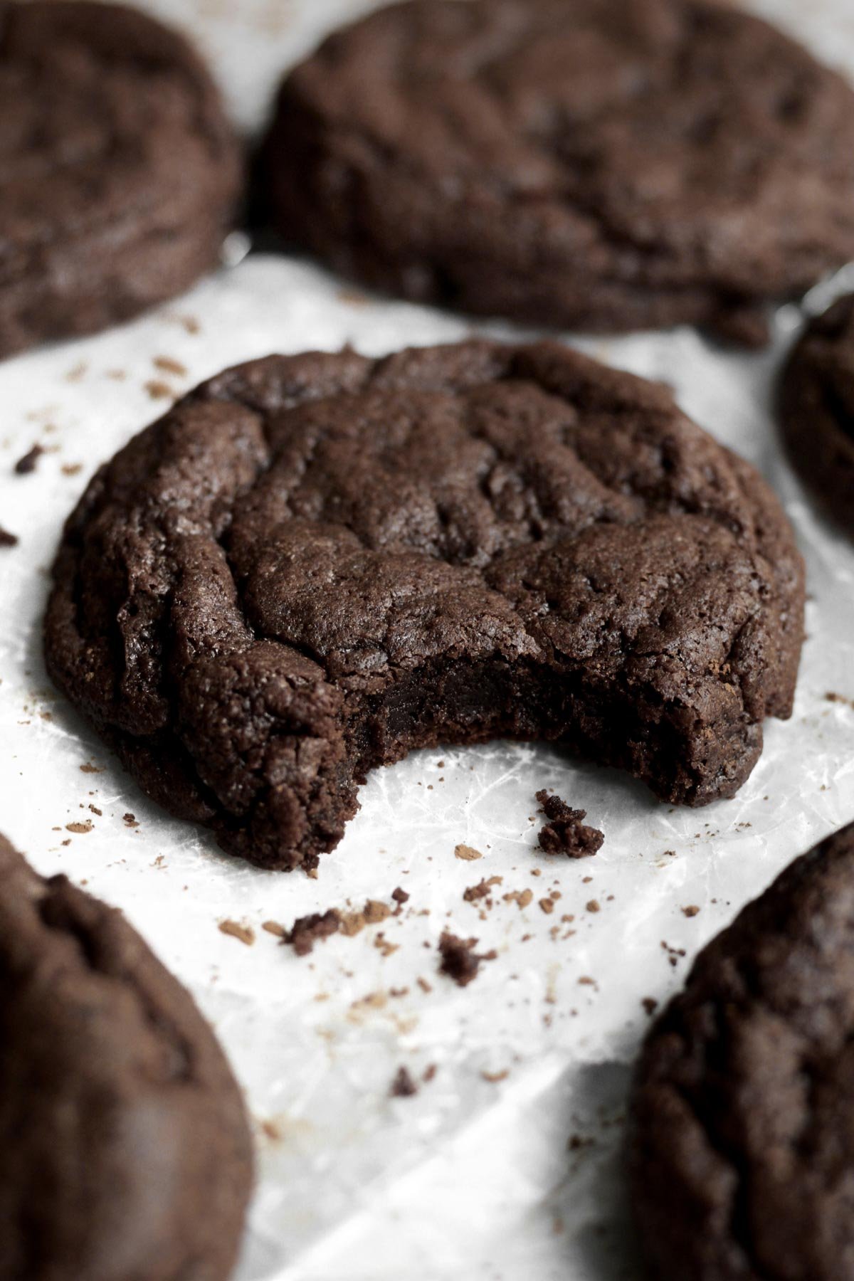 A bite reveals the delicious warm chocolatey interior of the Fudgy Brownie Cookies.