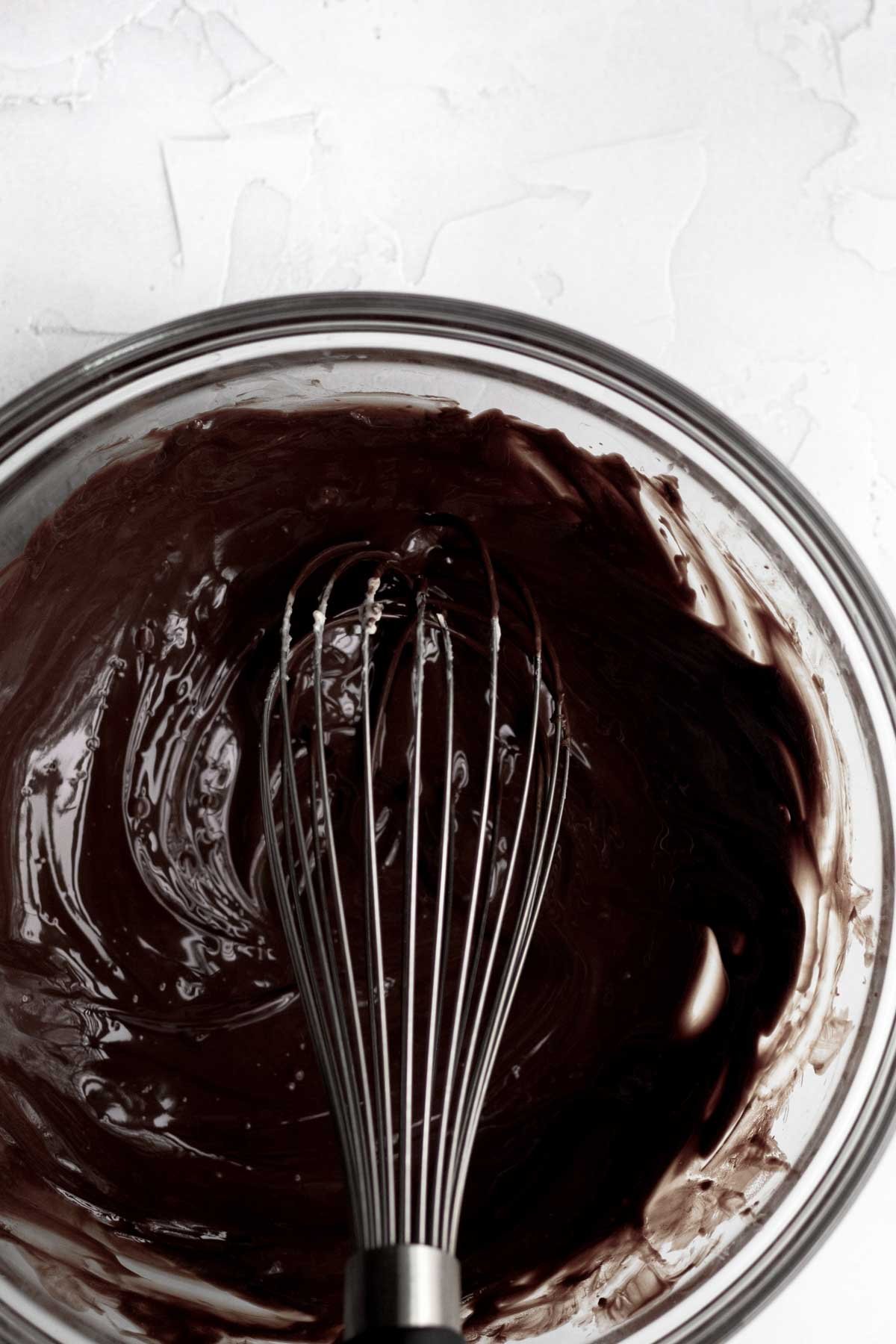 Mixing in cornstarch water into the melted chocolate mixture and sugar, vanilla, baking powder and salt. and then the homemade buttermilk.