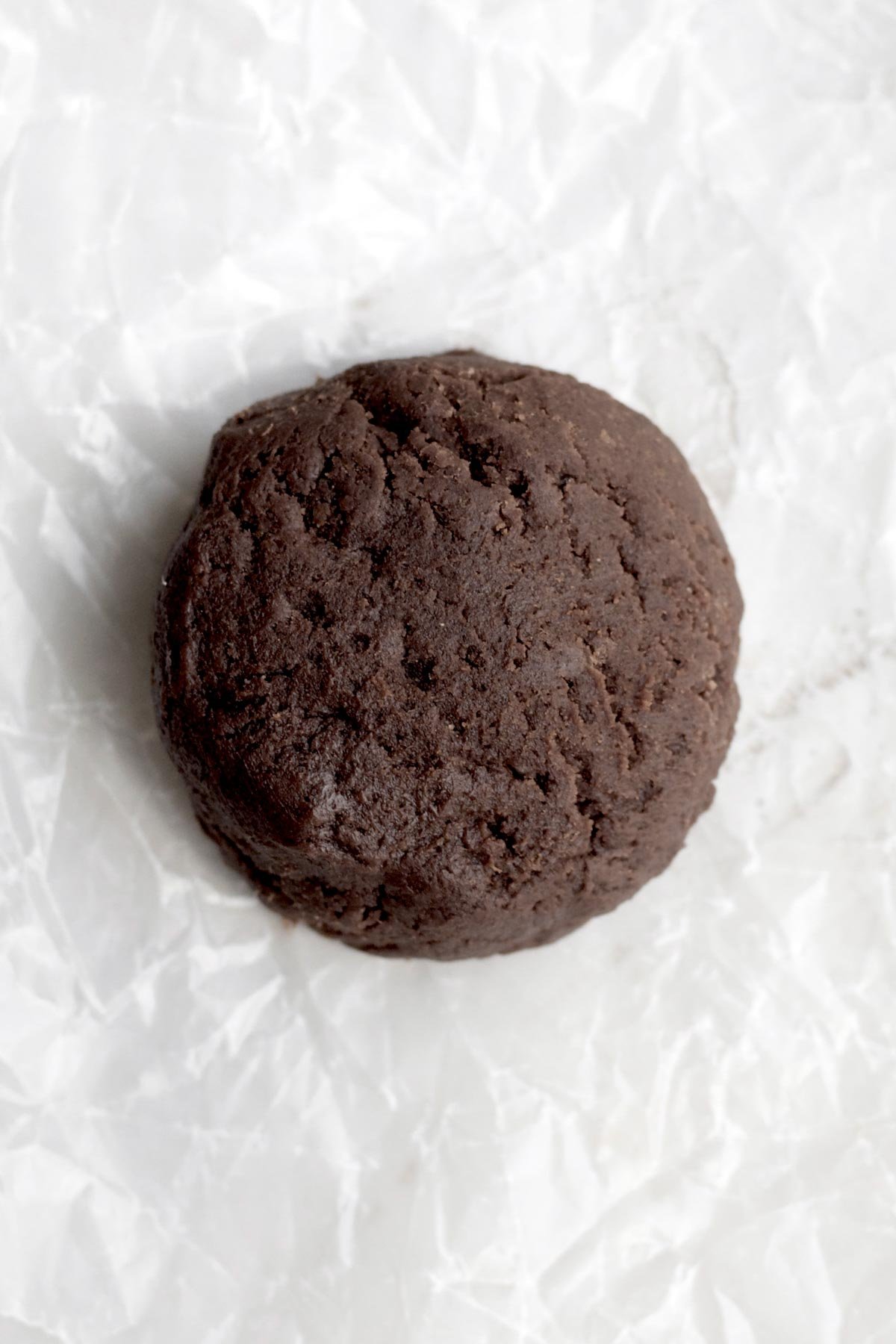 A scooped flattened ball of cookie batter.