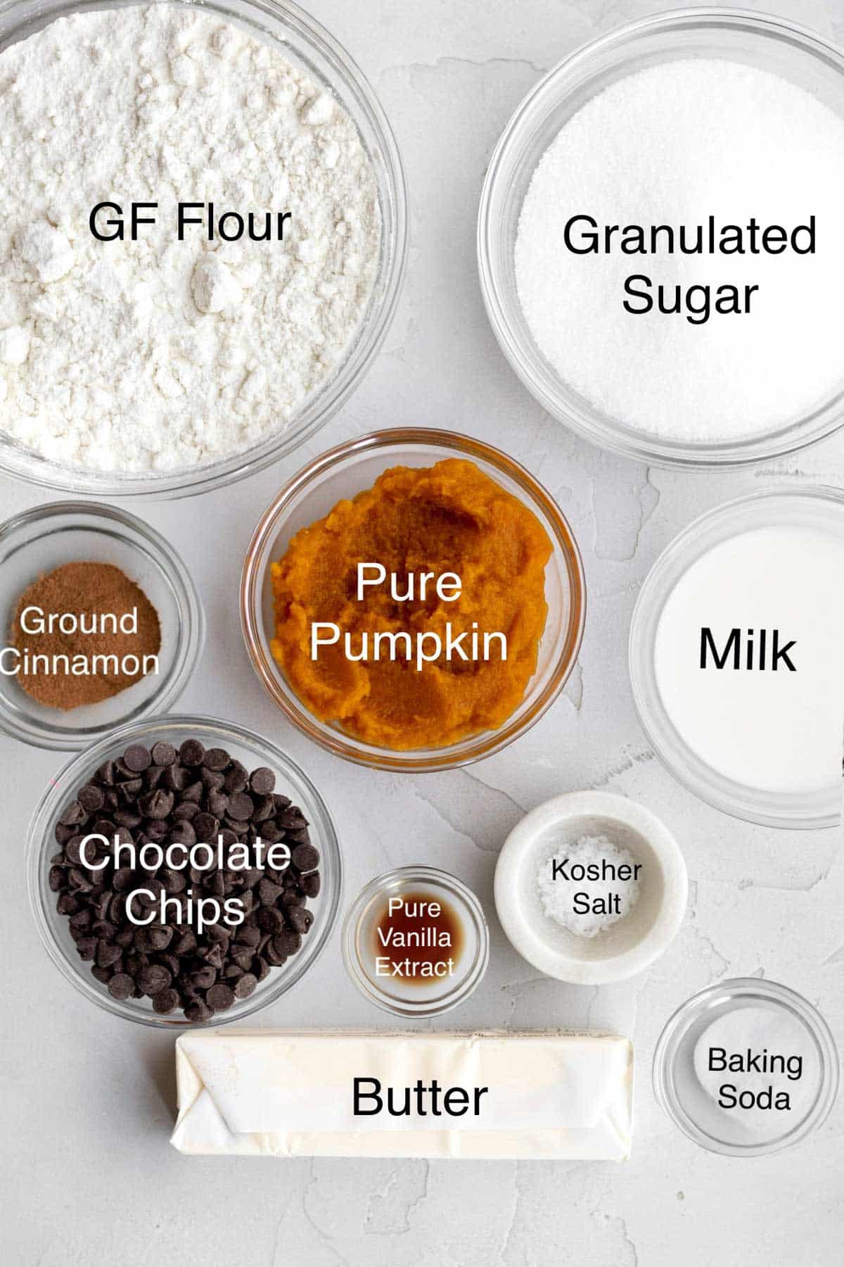 Gluten Free Flour, Granulated Sugar, ground cinnamon, pure pumpkin, milk, chocolate chips, pure vanilla extract, kosher salt, butter and baking soda in separate containers.