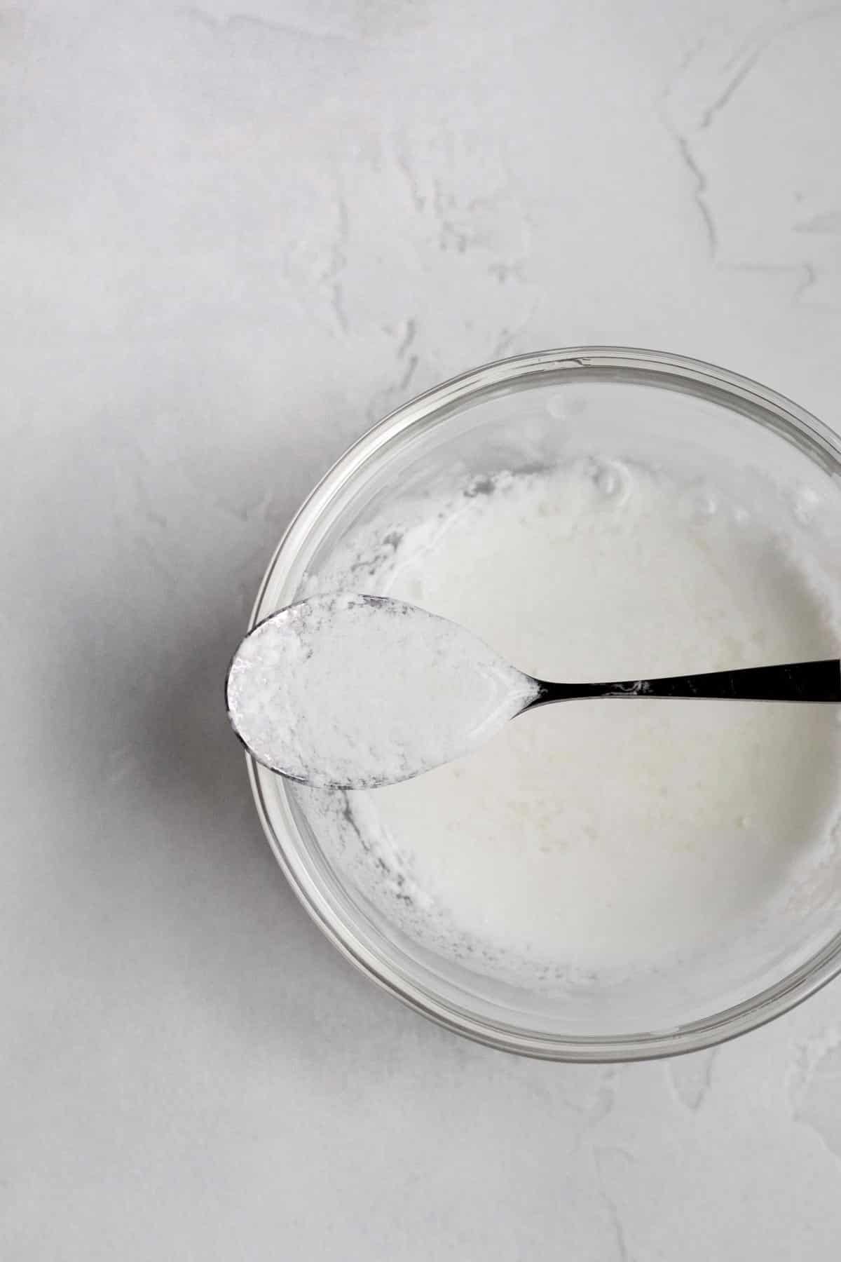 Homemade buttermilk on a spoon.