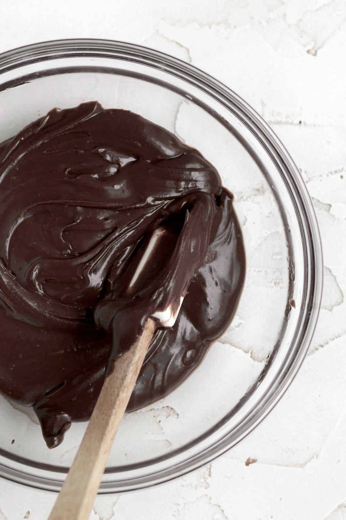 Mixing in cocoa powder to half of the vanilla icing in a separate bowl.