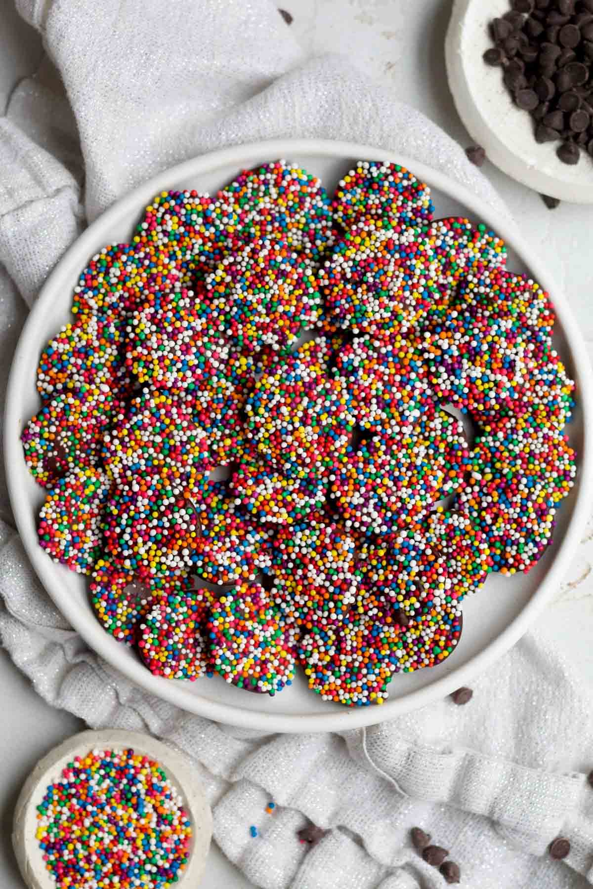 A plate of brightly colored rainbow Chocolate Nonpareils.