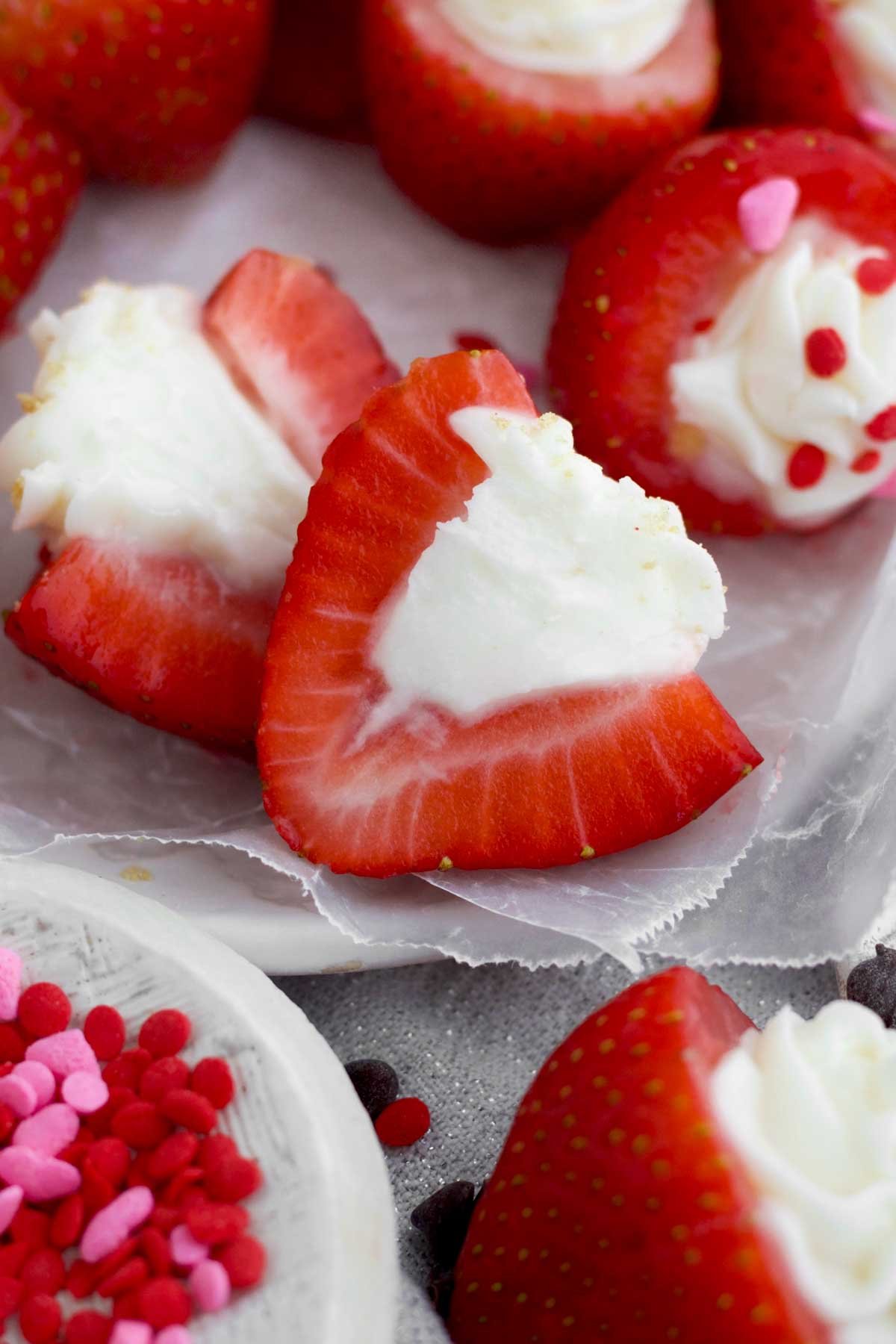 A Halved Cheesecake Stuffed Strawberry filled with sugary delicious creamy filling.