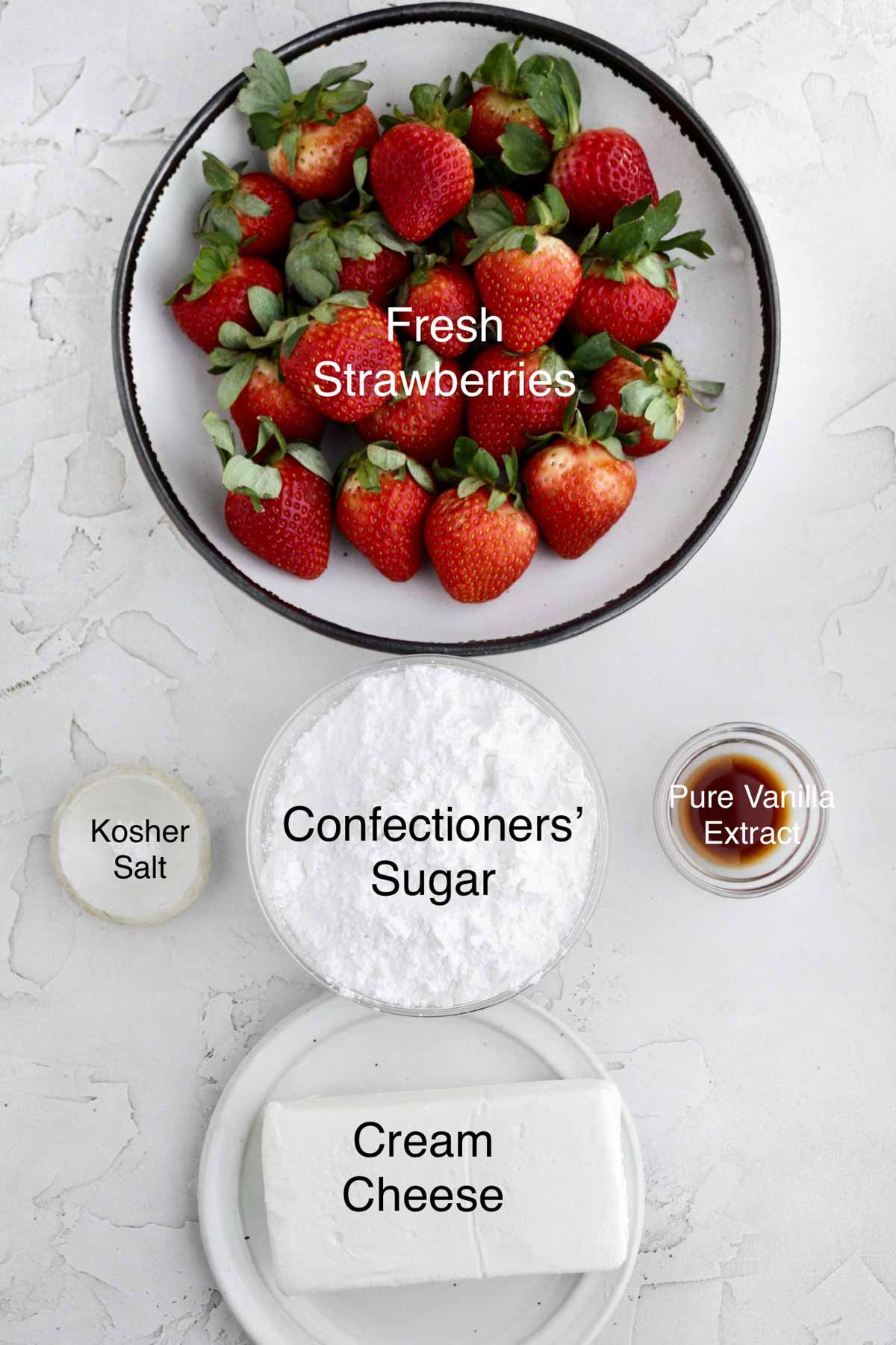 Separate containers of fresh strawberries, kosher salt, confectioners' sugar, pure vanilla extract, and cream cheese.