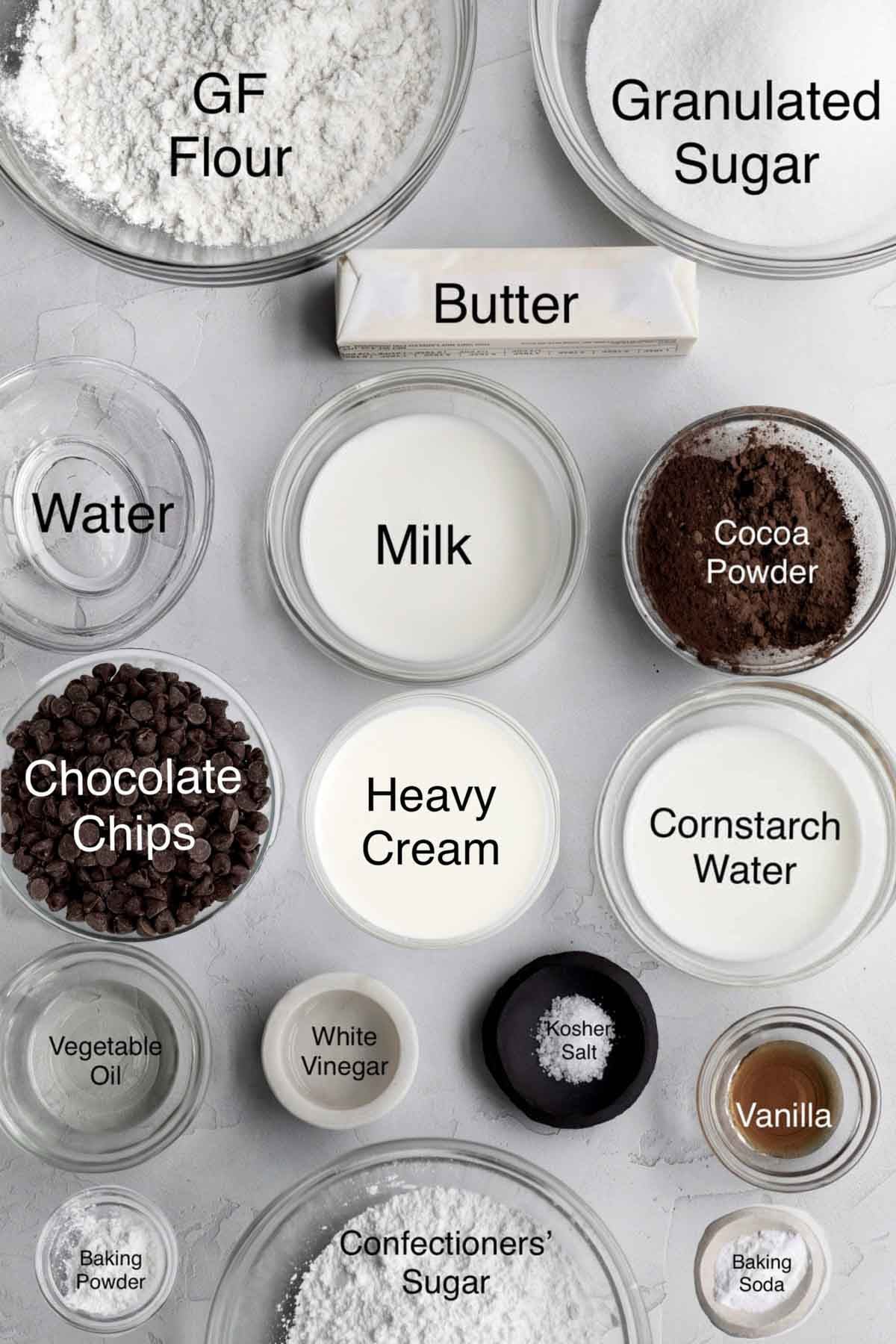 Chocolate Fudge Cupcakes Ingredients: gluten free flour, granulated sugar, butter, water, milk, cocoa powder, chocolate chips, heavy cream, cornstarch water, vegetable oil, white vinegar, kosher salt, vanilla, baking powder, confectioners' sugar and baking soda.