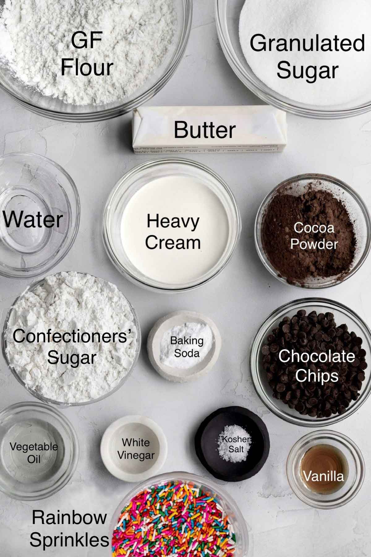 Chocolate Funfetti Cake Ingredients: gluten free flour, granulated sugar, butter, water, heavy cream, cocoa powder, confectioners' sugar, baking soda, chocolate chips, vegetable oil, white vinegar, kosher salt, vanilla and rainbow sprinkles.