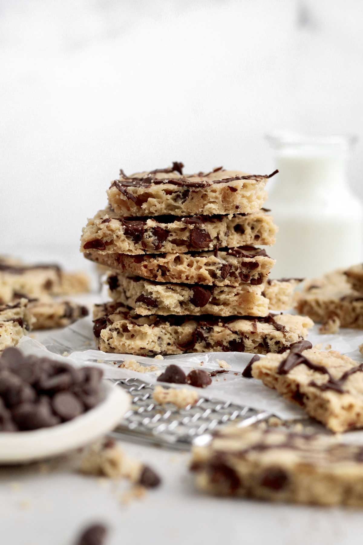 Stacked crunchy cookie brittle pieces showcasing their airy texture amongnst the chocolate chips.